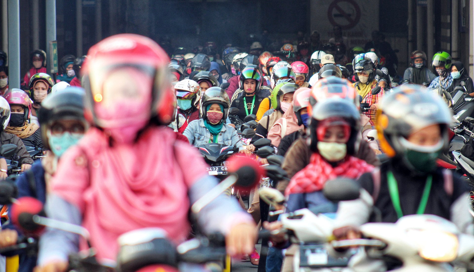 Buruh meninggalkan pabrik saat jam pulang kerja