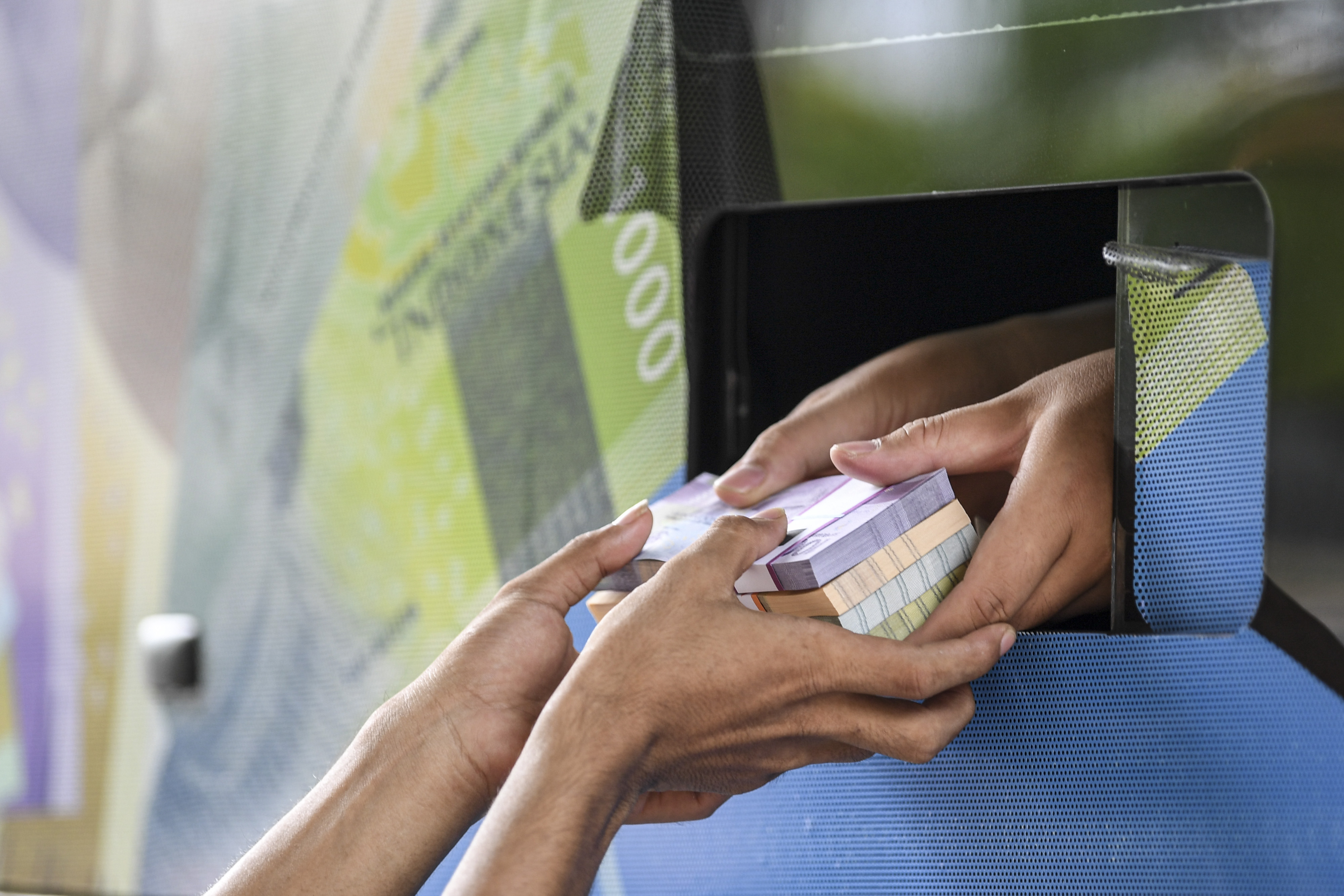 Ilustrasi: Warga menerima uang baru yang ditukarkan pada mobil kas keliling Bank Indonesia (BI) di Pasar Koja Baru, Jakarta Utara