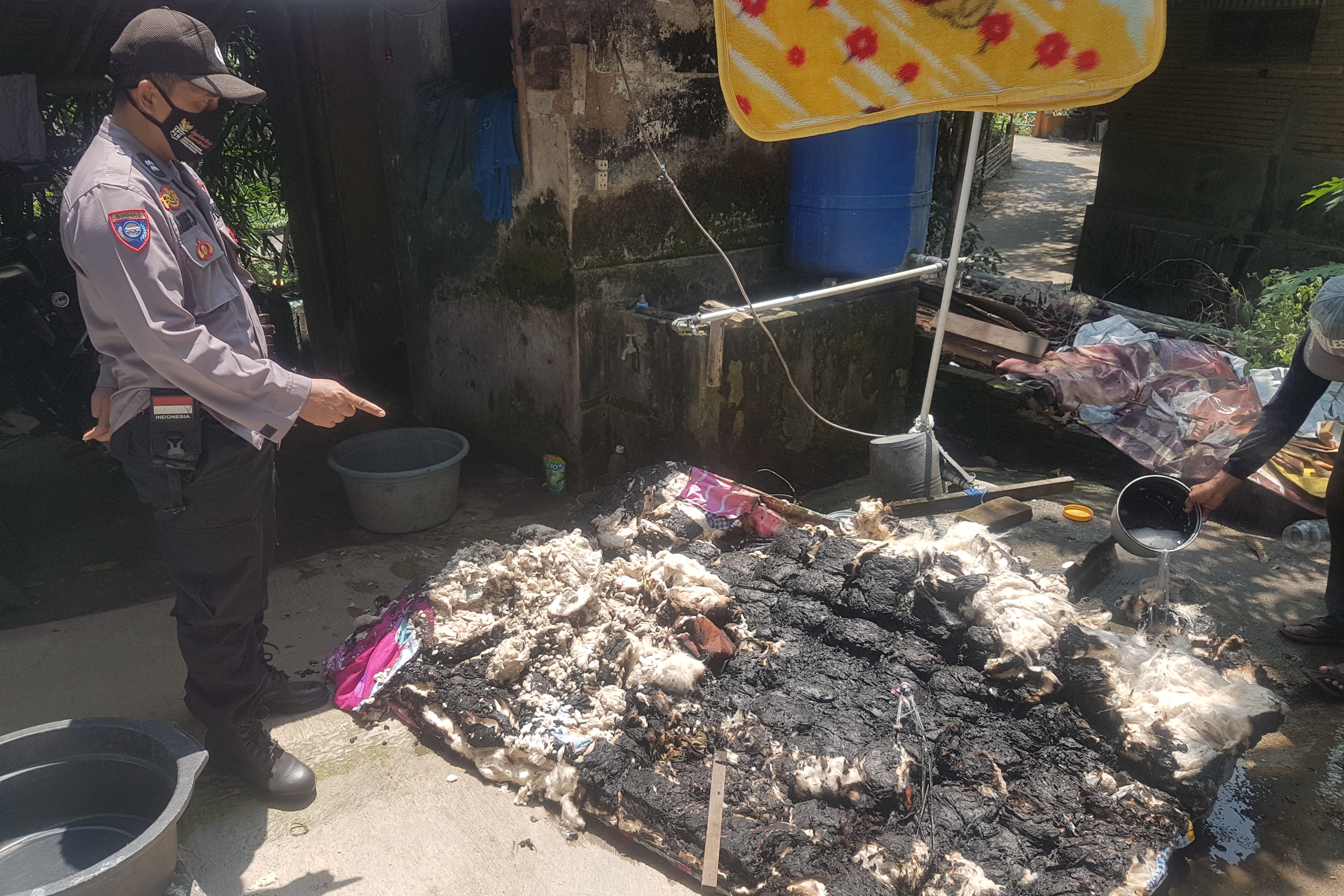 Polisi menunjuk kasur sebagai barang bukti usai dibakar seorang ayah terhadap anak dan istri di Desa Klumpit, Gebog, Kudus, Sabtu (16/4).