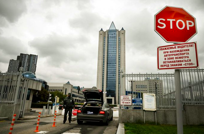 Petugas memeriksa kendaraan yang akan masuk ke area gedung perusahaan gas Gazprom di Moskow, Rusia.