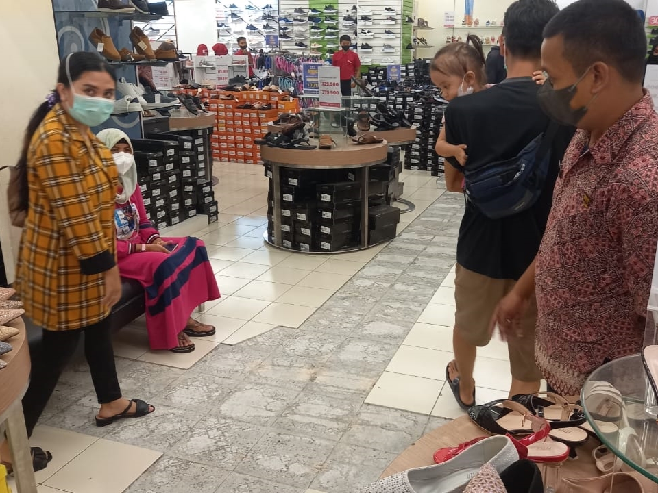 Petugas menunjukkan lantai keramik retak setelah ratusan pengunjung panik saat belanja di Mal Matahari.