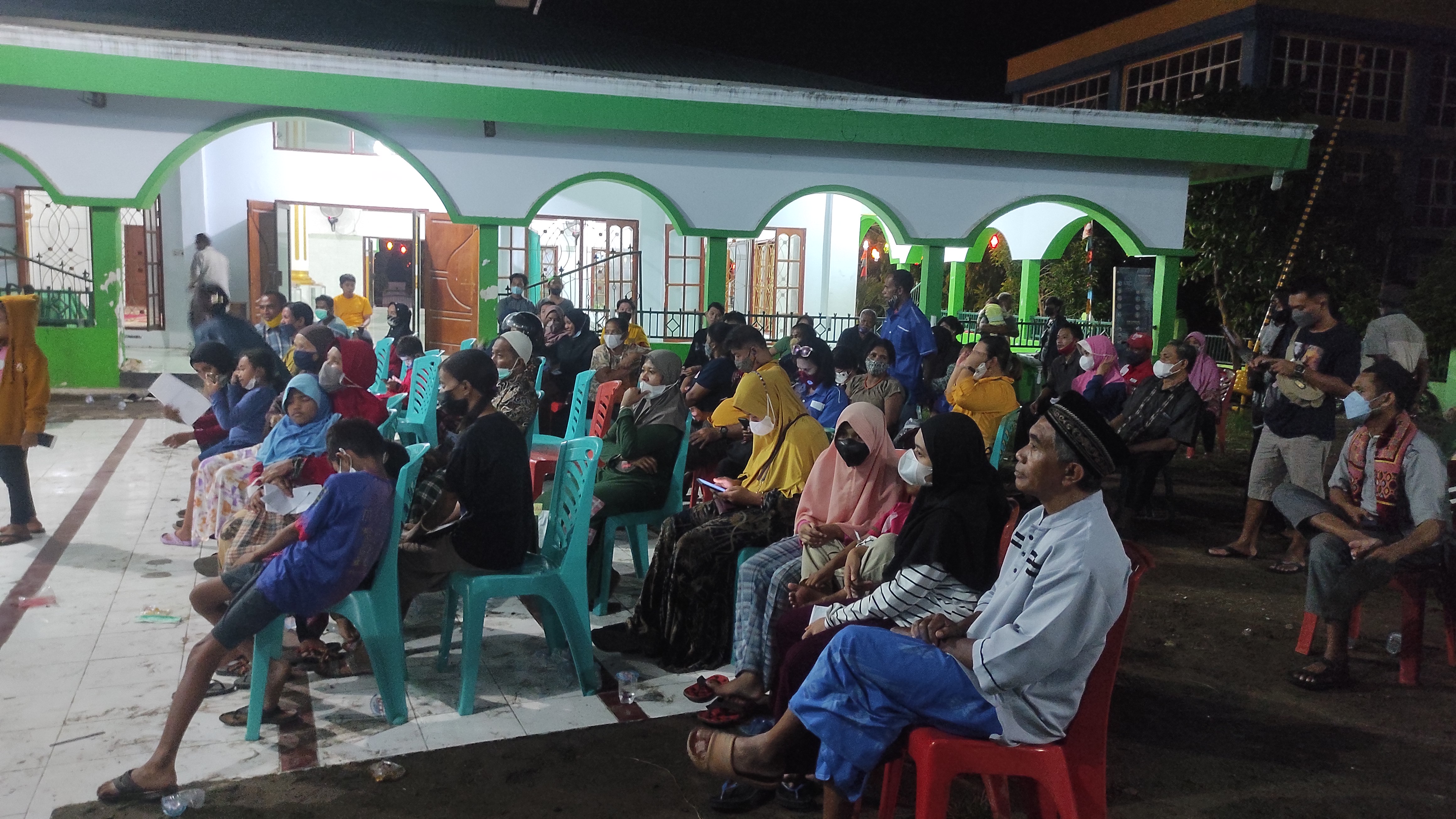 Warga membaur saat vaksinasi covid dilaksanakan di Masjid Darussalam Waioti, Kabupaten Sikka, Minggu malam (17/4)