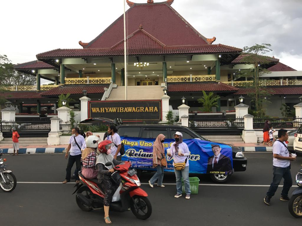 RATUSAN masyarakat Jember, Jawa Timur yang tergabung dalam Sandi Uno Fans Club Jember membagikan takjil dan alquran, Senin sore.