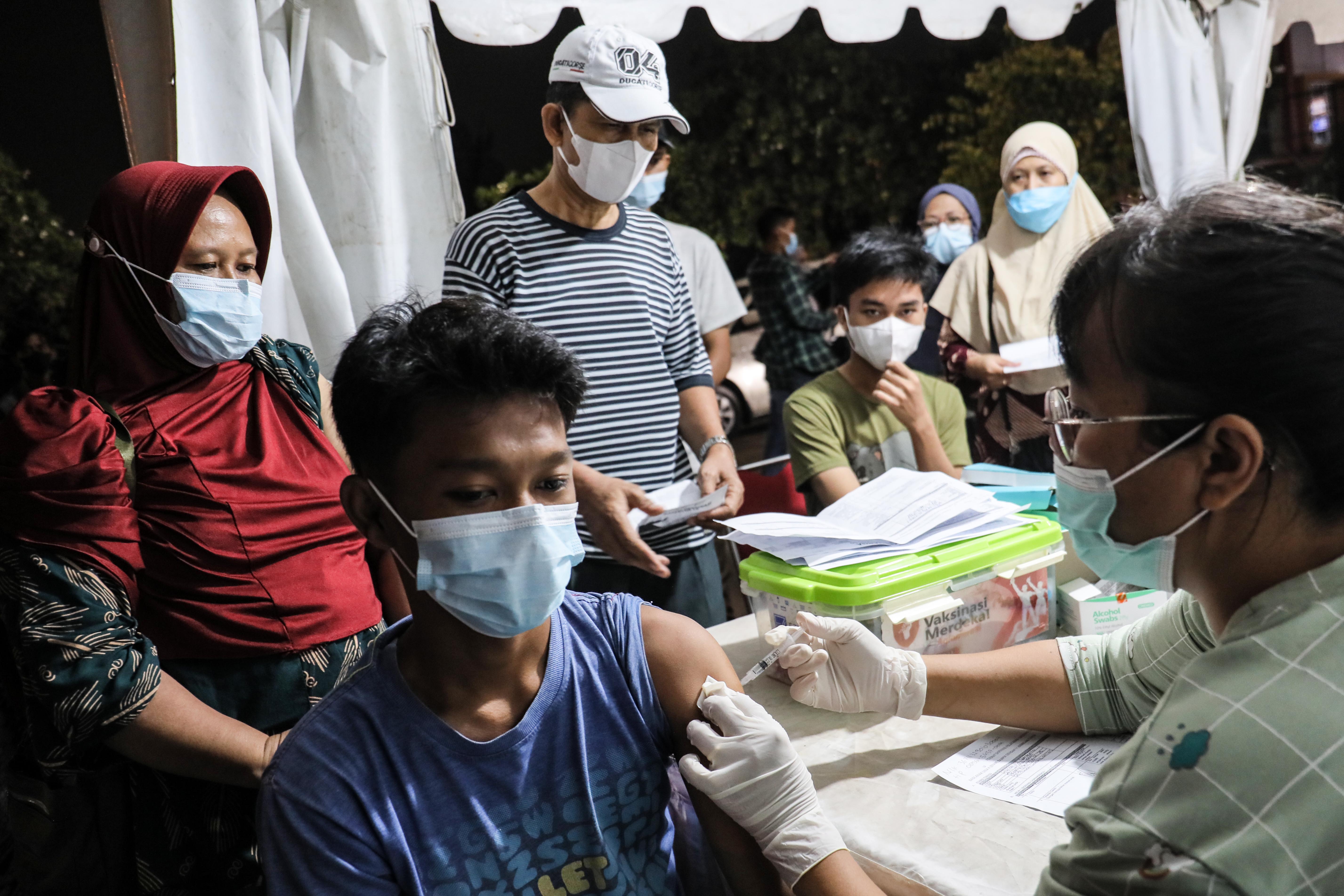 Warga antusias mengikuti vaksinasi covid-19 untuk dosis 1, 2 dan Booster di lokasi pasar malam kawasan Puri Beta 2 Ciledug, Kota Tangerang.