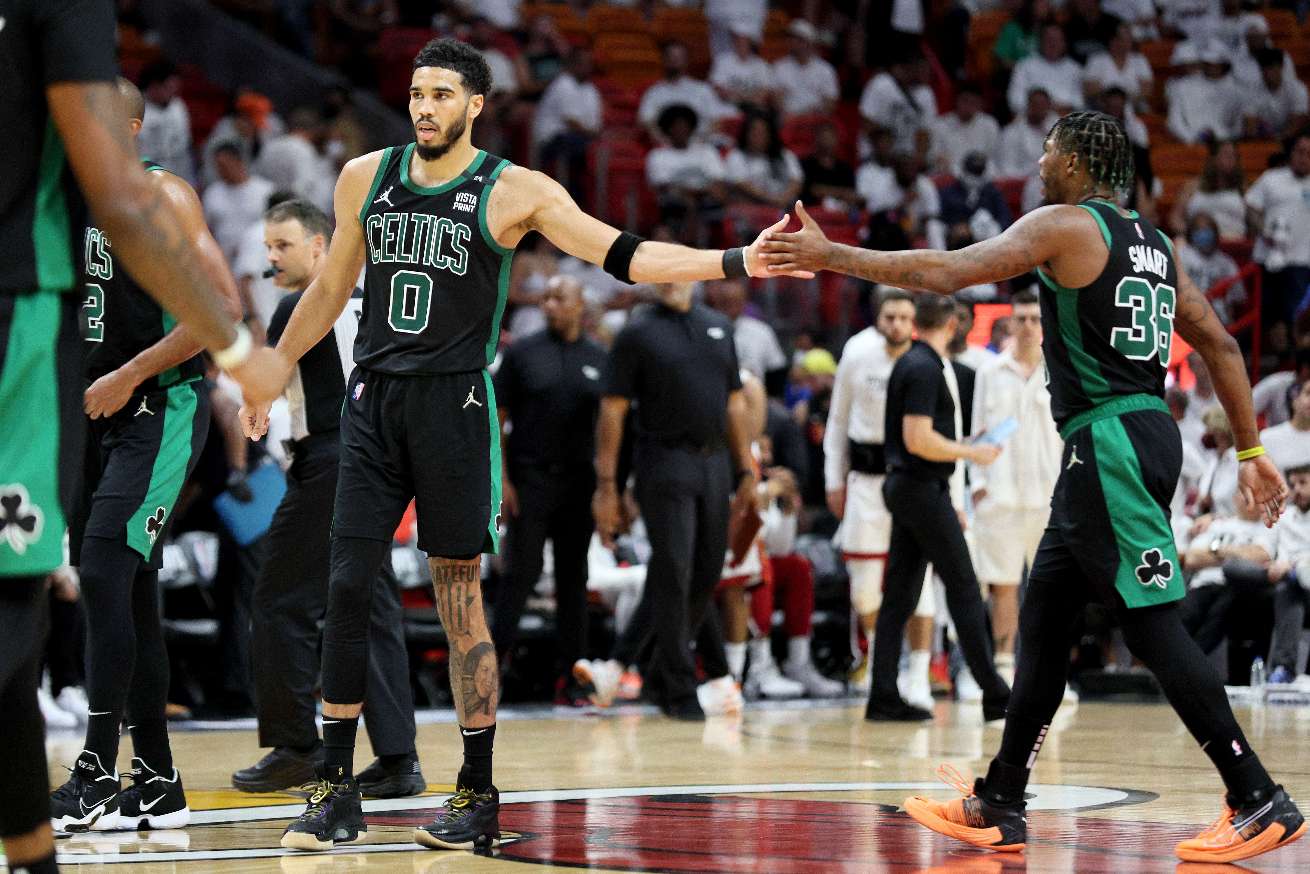Pemain Boston Celtics Jayson Tatum melakukan tos dengan rekannya Marcus Smart di Gim 5 Final Wilayah Timur NBA melawan Miami Heat.