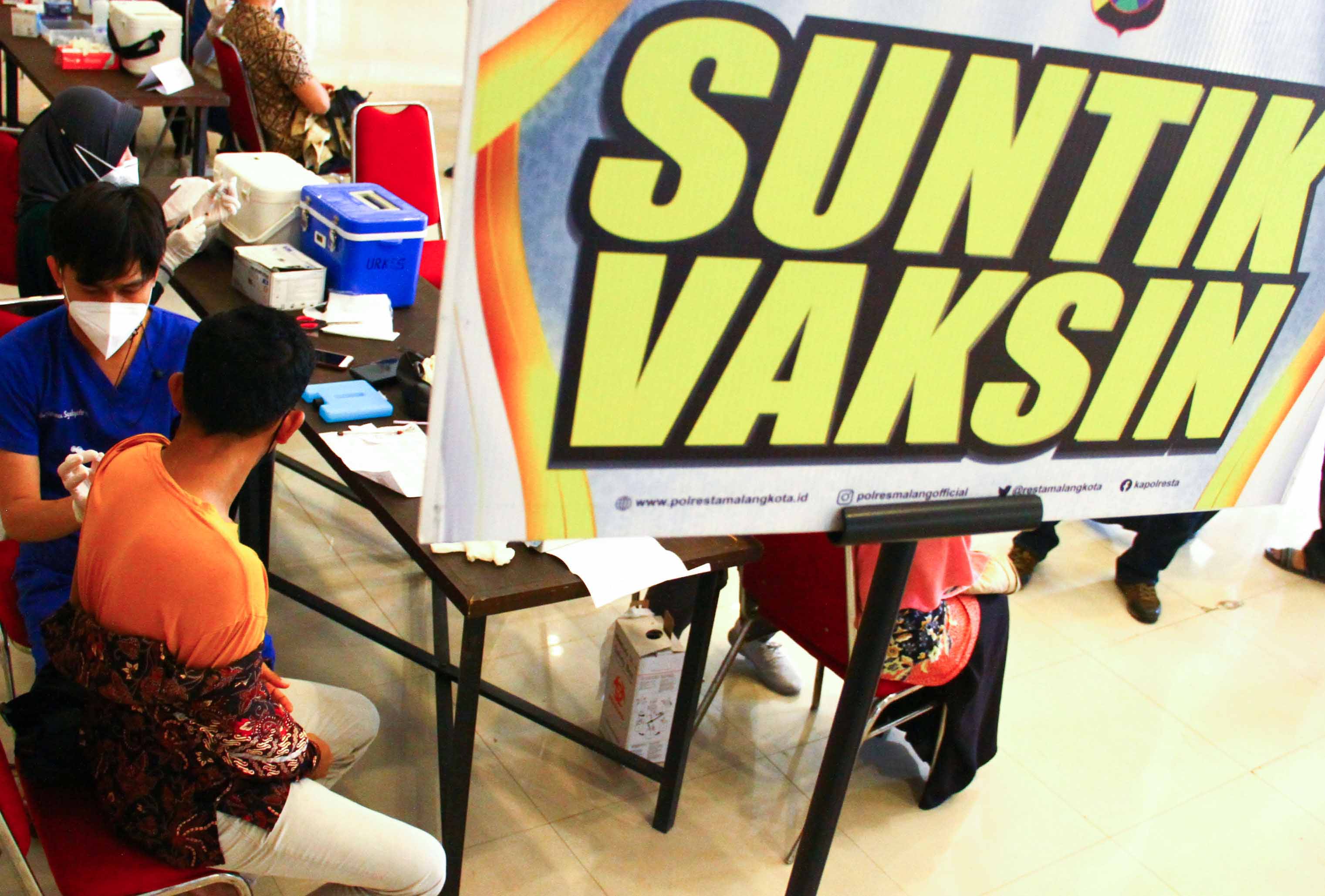 Petugas medis menyuntikkan vaksin covid-19 dosis booster kepada warga.