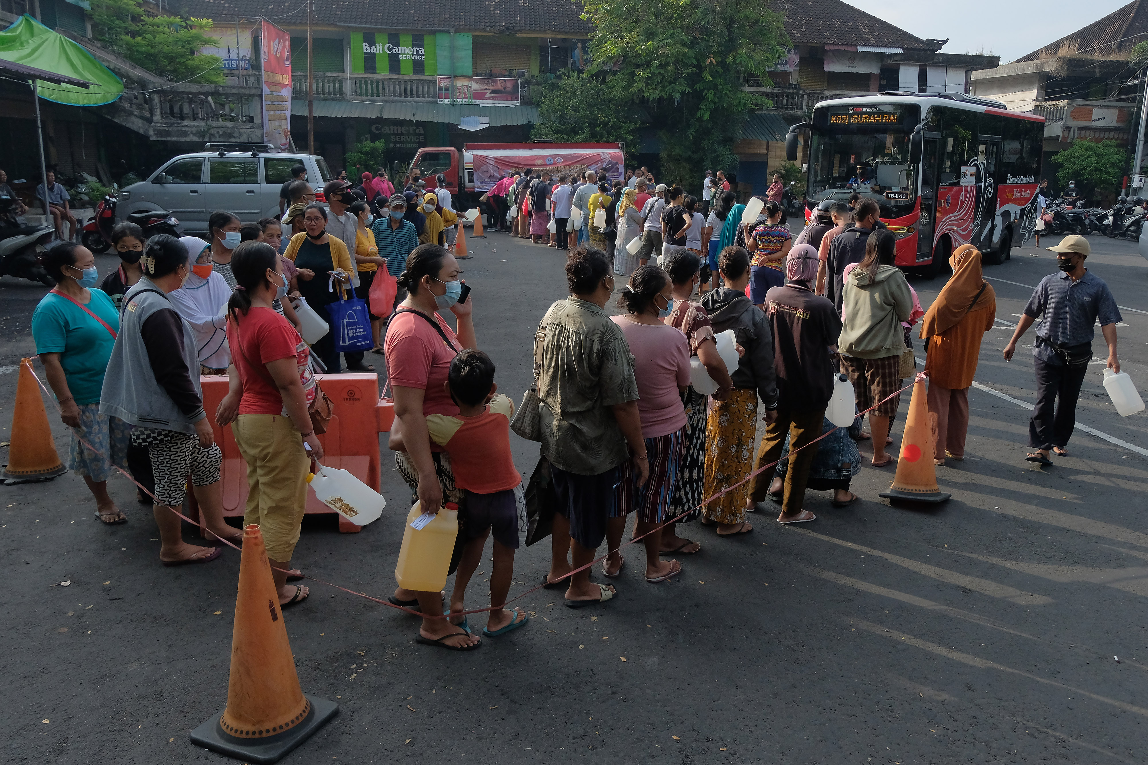 Warga antre membeli minyak goreng curah pada Gebyar 2 Ton Minyak Goreng Curah di Terminal Tegal, Denpasar, Bali, Sabtu (30/4/2022)