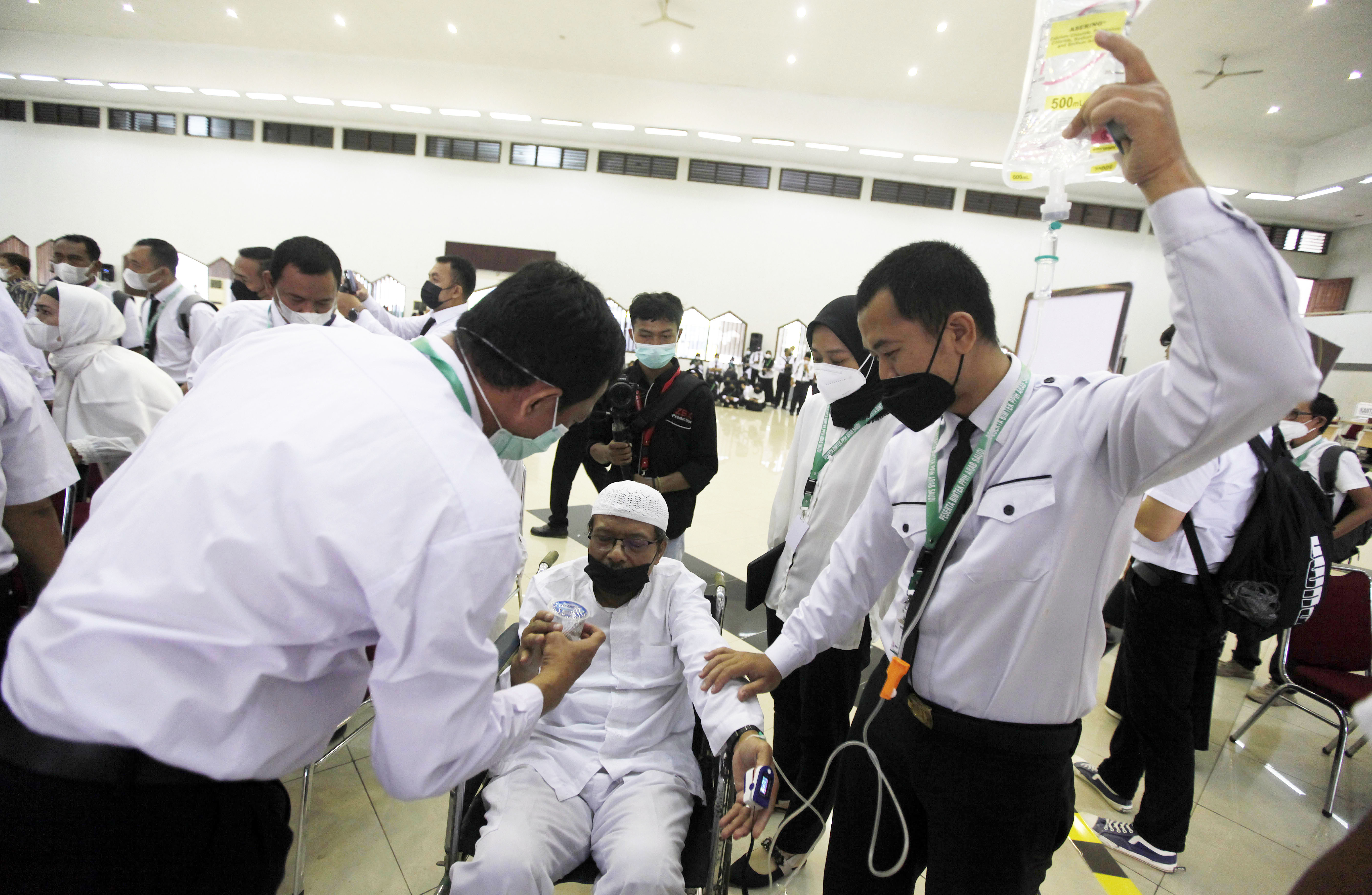 Ilustrasi PPIH membantu jemaah haji yang sakit