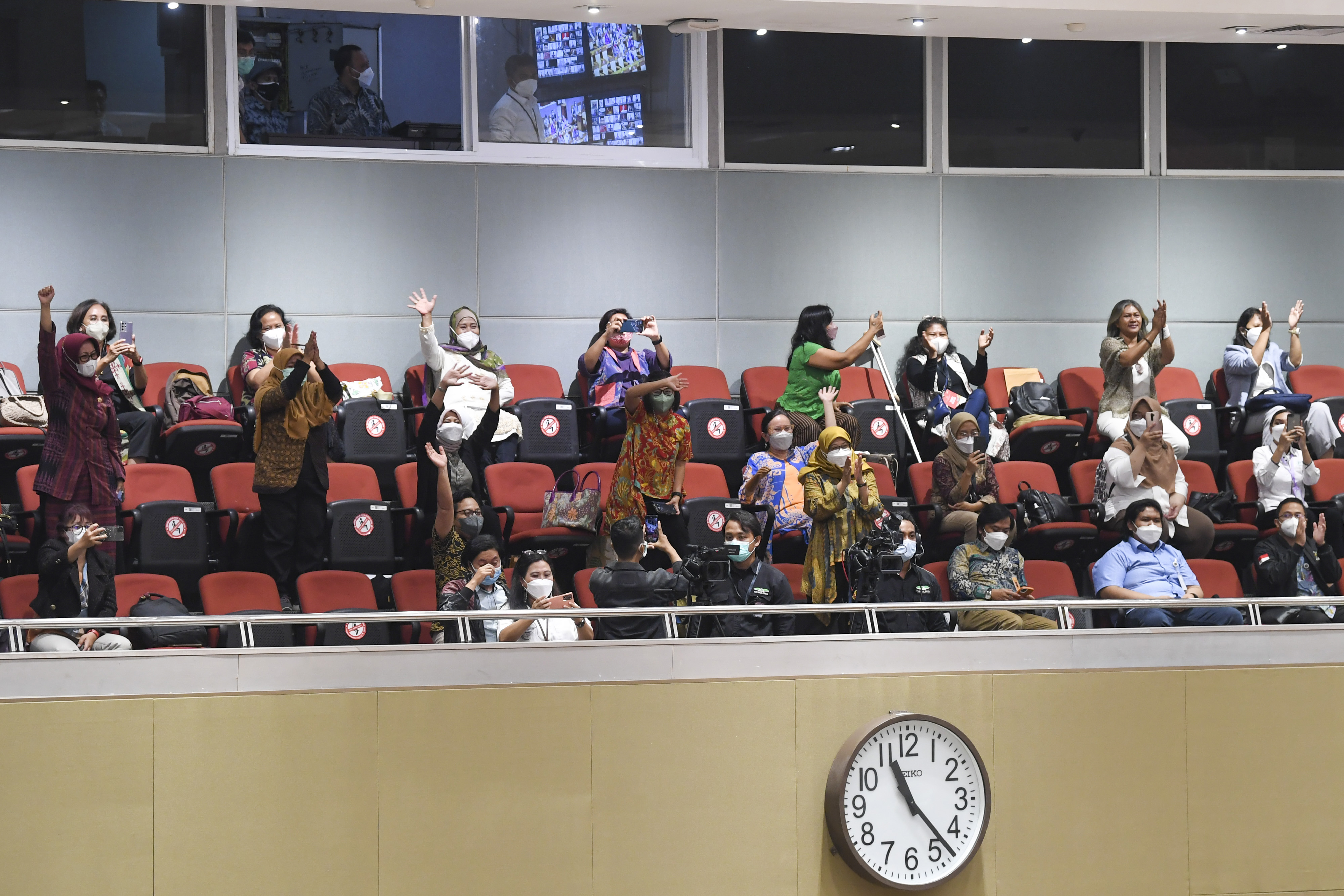 Pengunjung melambaikan tangan usai pengesahan UU TPKS dalam Rapat Paripurna DPR RI di Kompleks Parlemen, Jakarta, Selasa (12/4/2022)