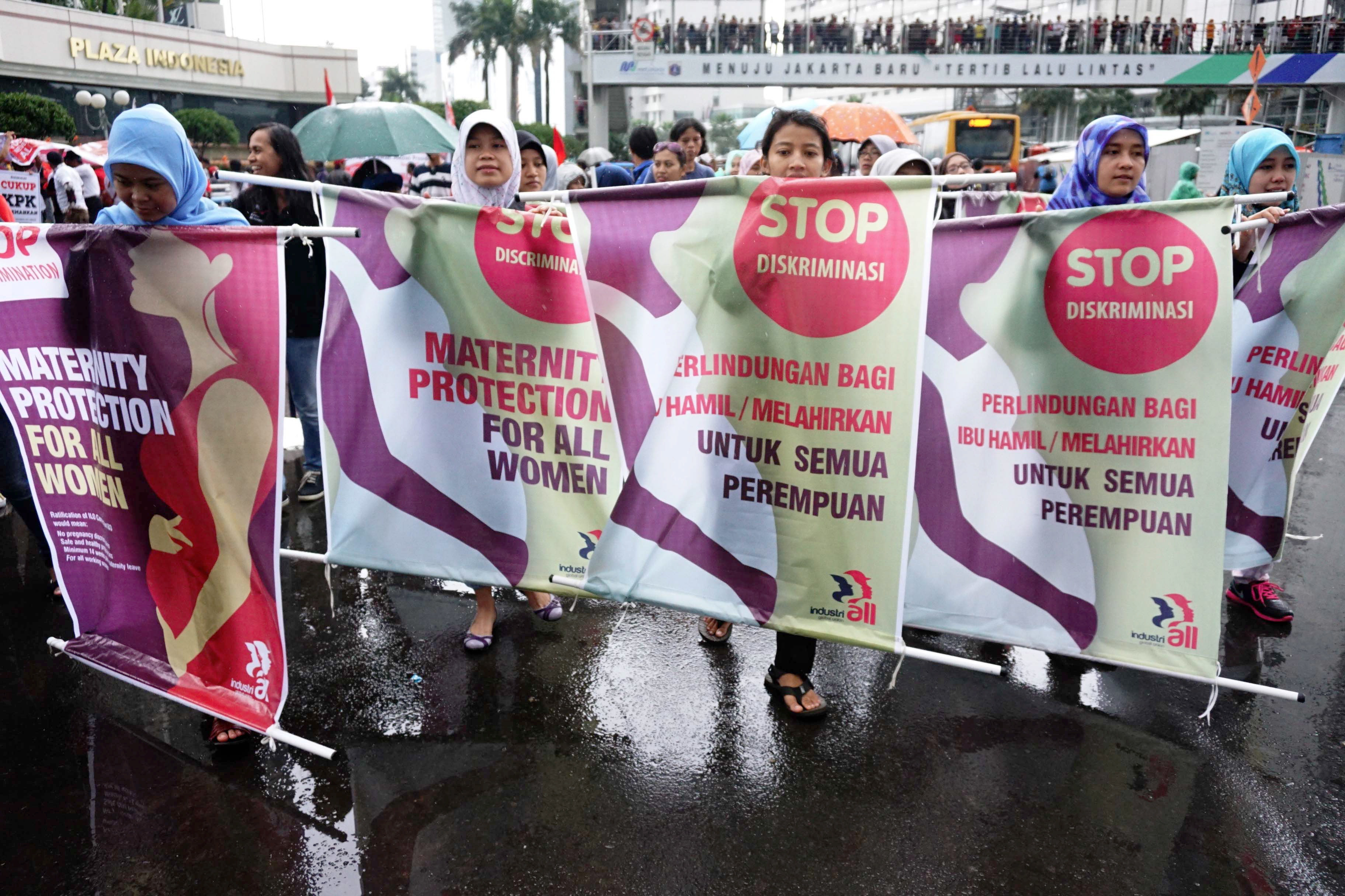 Sejumlah buruh perempuan membawa poster pelindungan dan penghentian diskriminasi terhadap perempuan saat melakukan aksi di Bunderan HI.