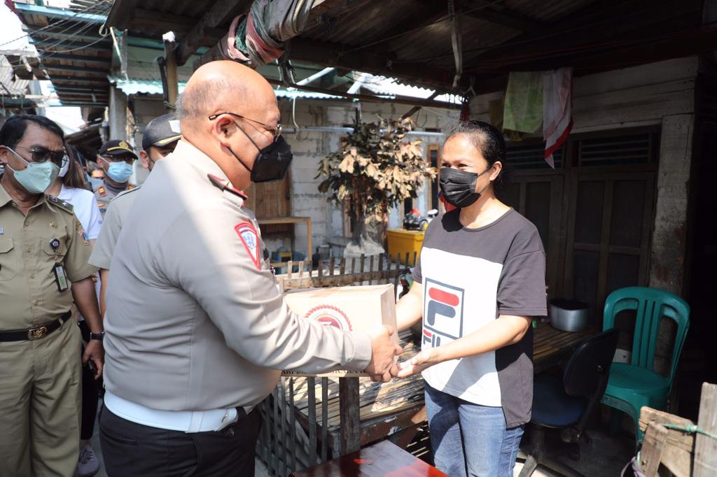 Dirkamsel Korlantas Polri Brigjen Pol Chrisnanda Dwi Laksana memberikan bantuan sosial kepada salah satu warga nelayan Cilincing, Jakut, Sel