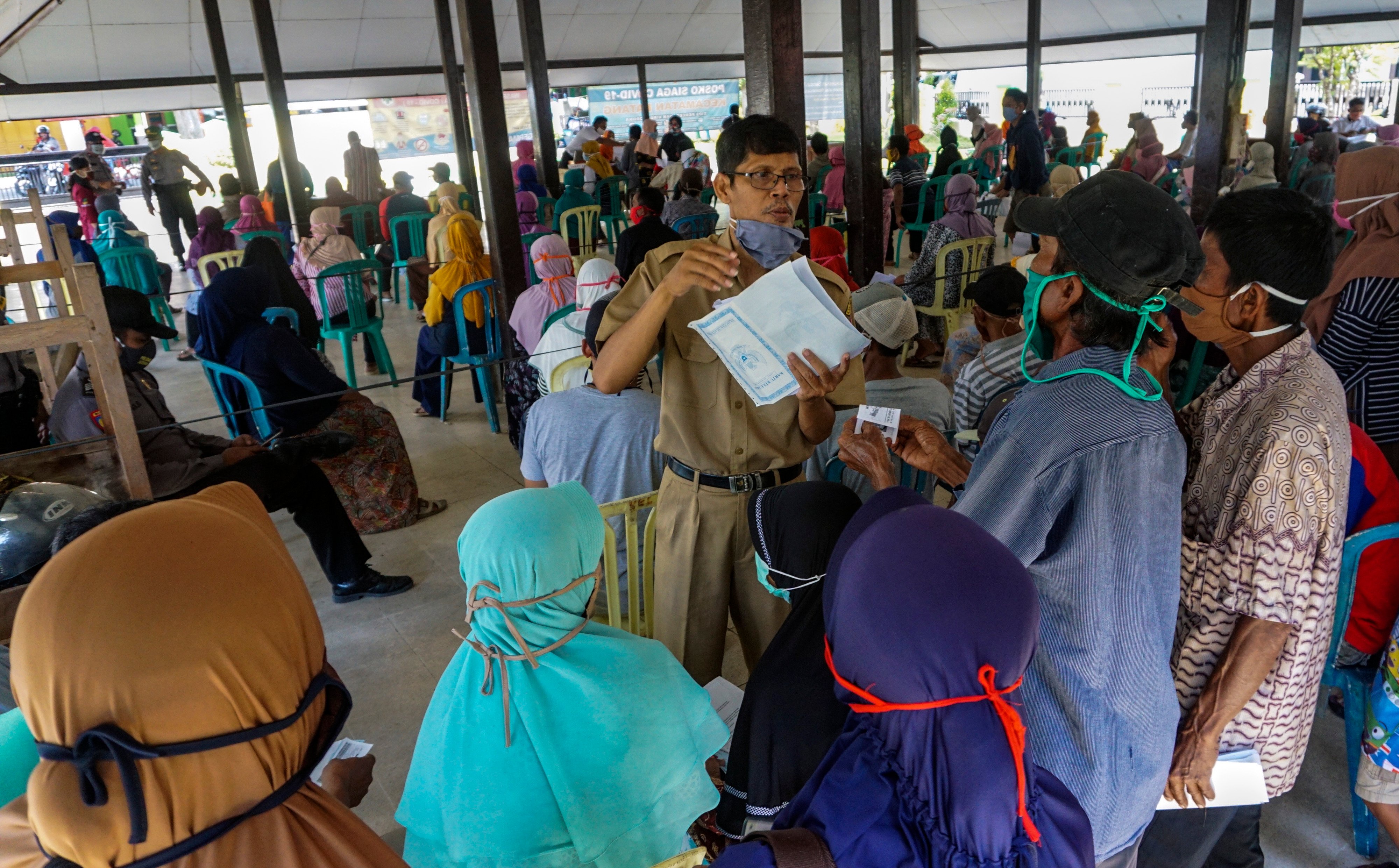 Sejumlah warga mengantre untuk menerima bantuan sosial di Kabupaten Batang, Jawa Tengah.