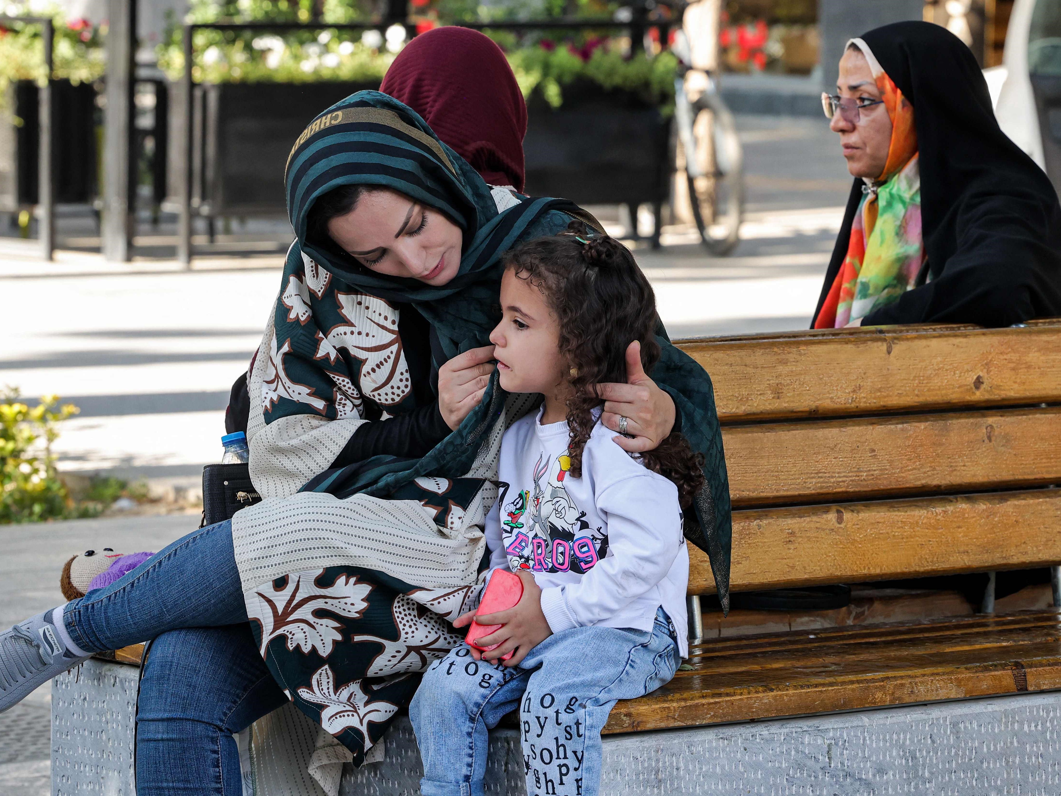 Seorang wanita menggunakan cadarnya untuk menggosok wajah seorang gadis di sepanjang Chaharbagh Boulevard, Isfahan, Iran.