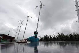 Ilustrasi: Energi terbarukan hybrid, PLTS dan kincir angin.