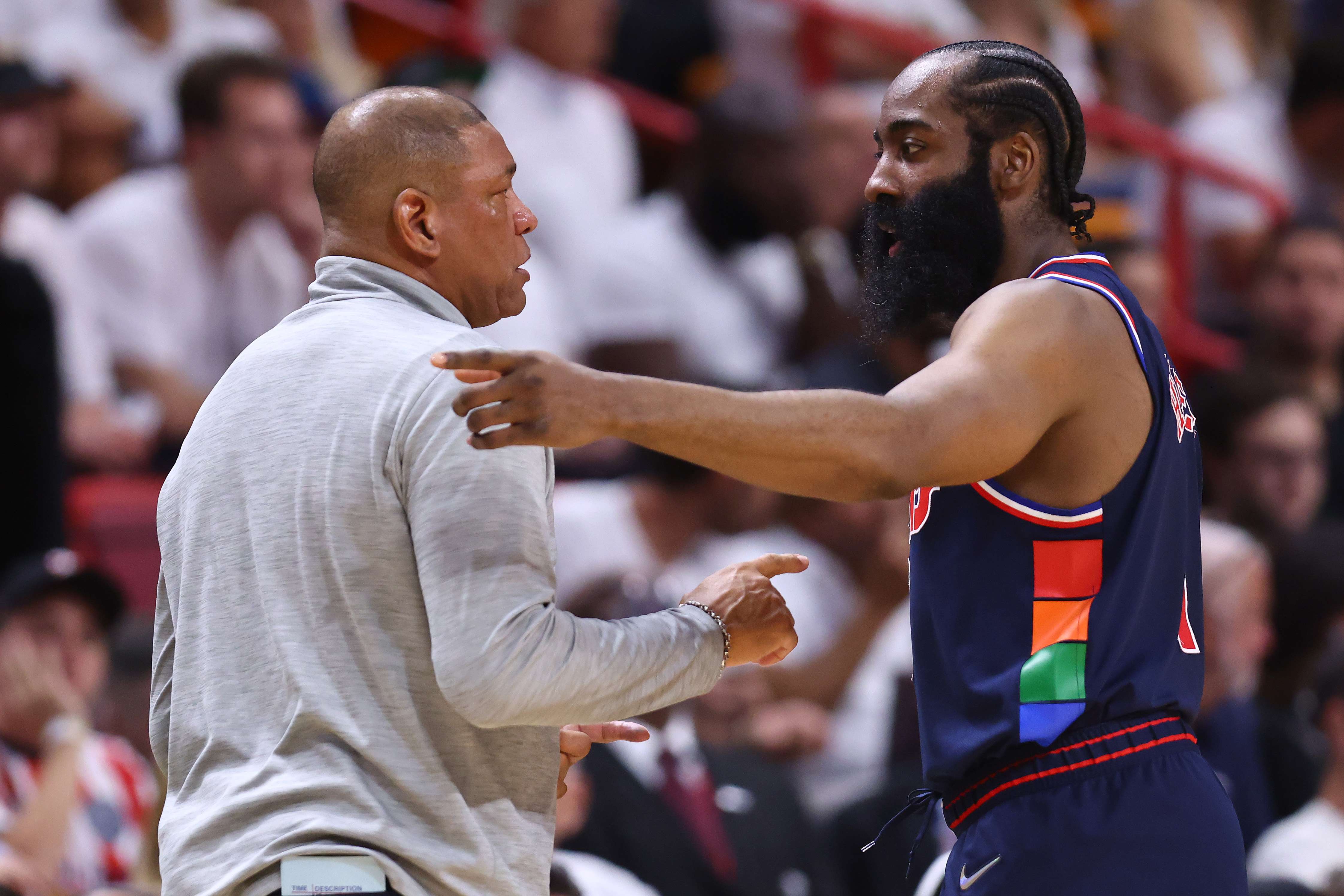 Pemain Philadelphia 76ers James Harden berbincang dengan pelatih Doc Rivers saat timnya menghadapi Miami Heat.