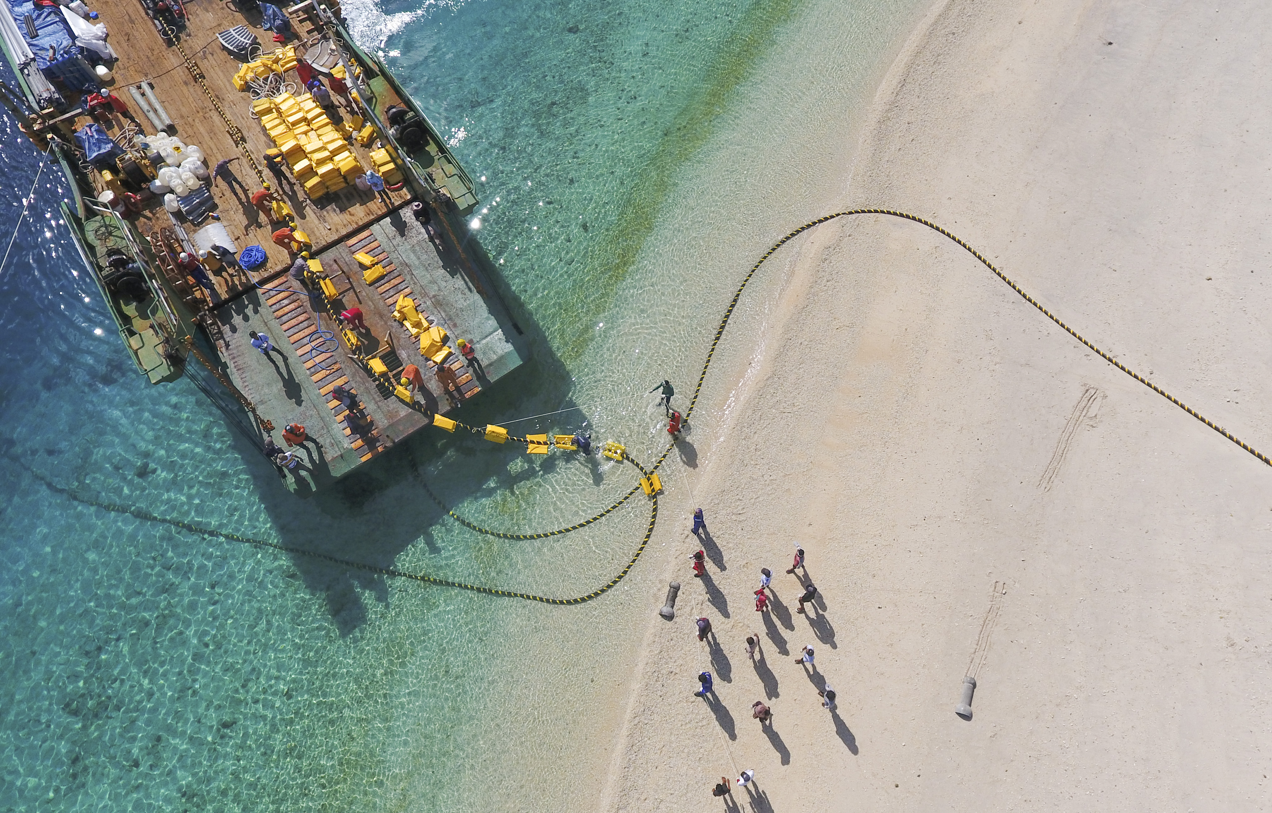 Foto udara kapal pendarat tank (Landing Craft-Tank) Surya Agung melakukan penambahan kabel bawah laut sistem kelistrikan 