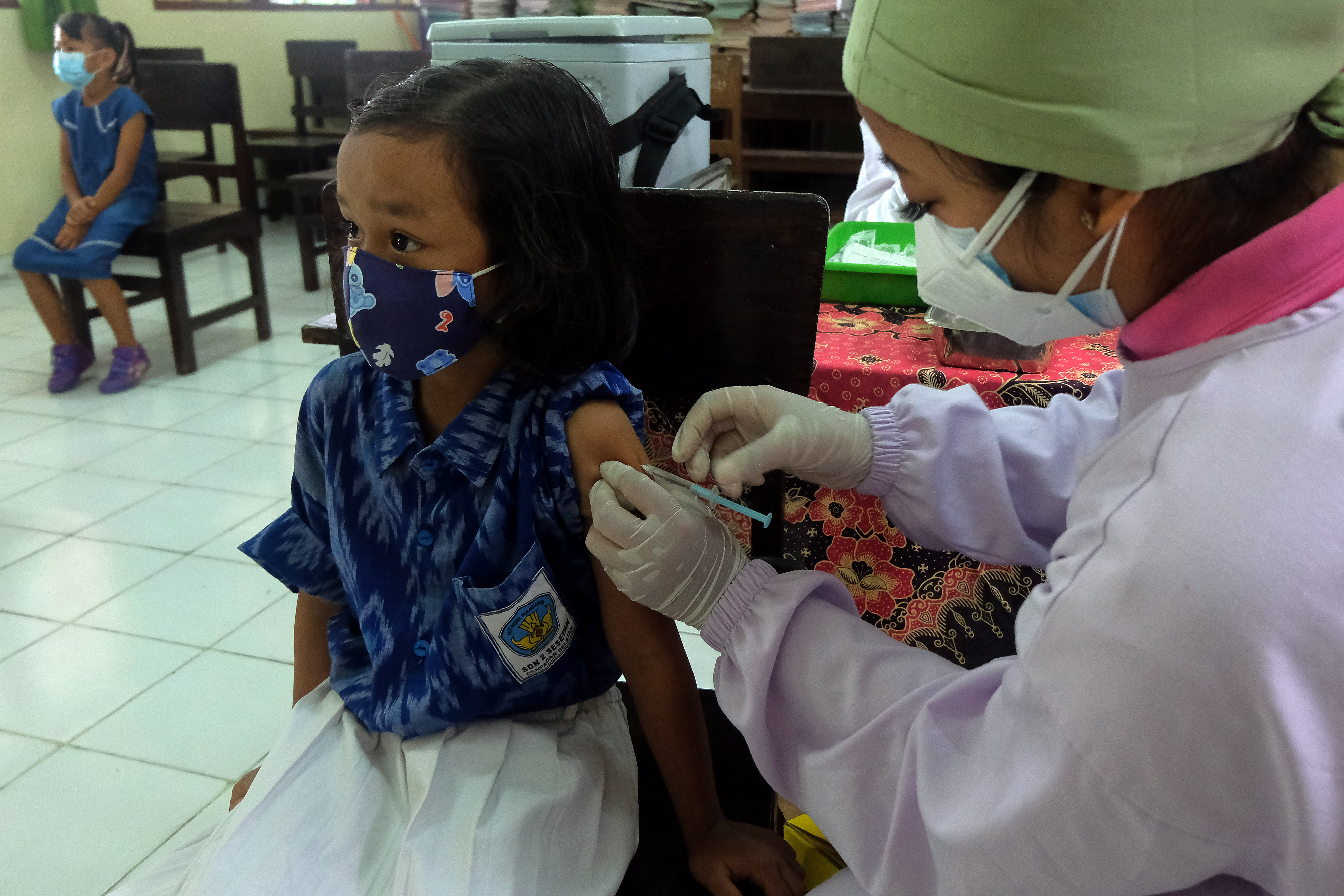  IMUNISASI CAMPAK RUBELLA: Petugas kesehatan menyuntikkan vaksin measles rubella kepada siswa saat BIAS di SD Negeri 2 Sesetan, Bali.