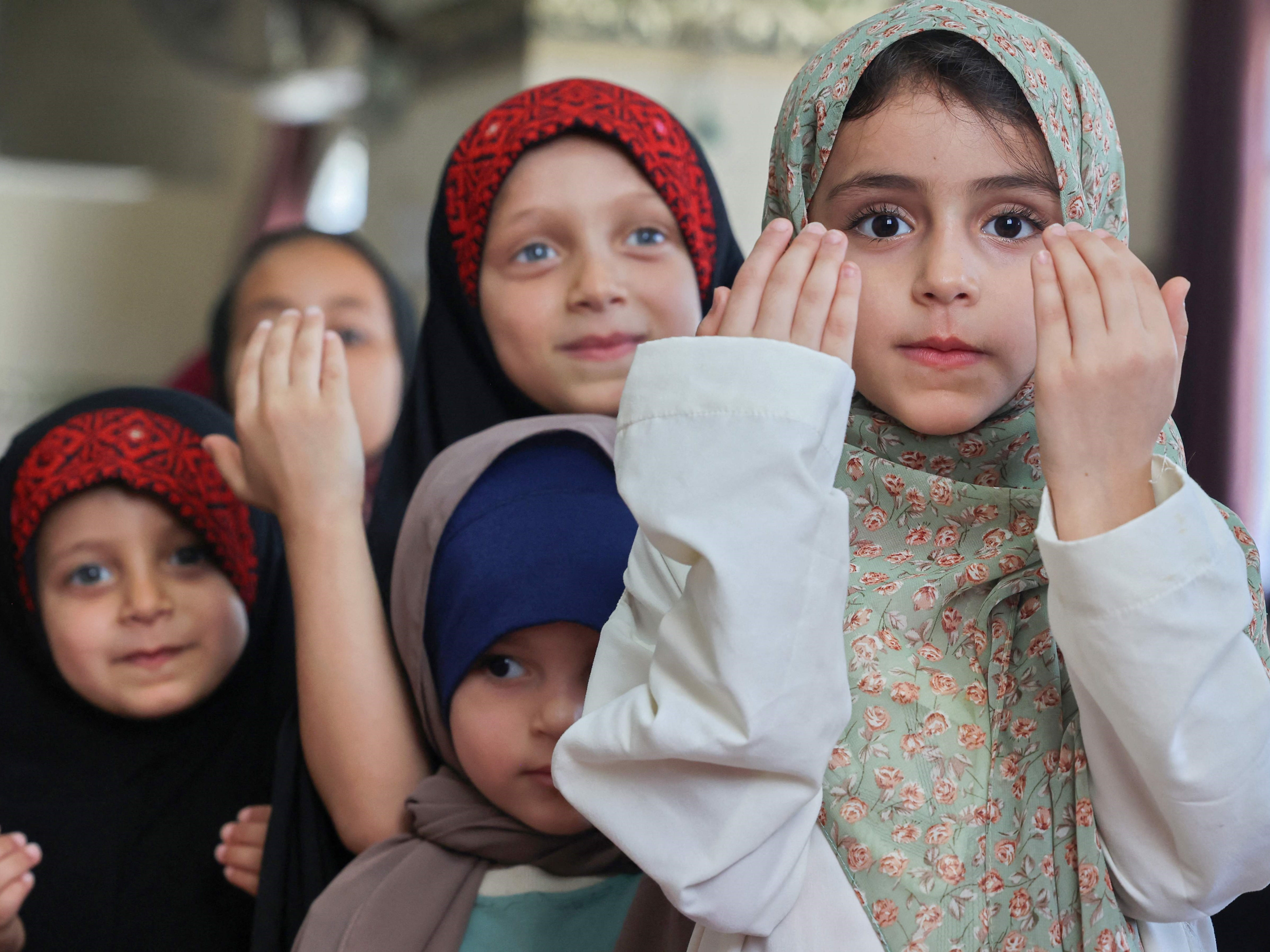 Gadis-gadis Palestina berdoa selama program hafalan kamp musim panas yang didukung oleh gerakan Islam Hamas di kota Gaza, pada 7 Juni 2022. 