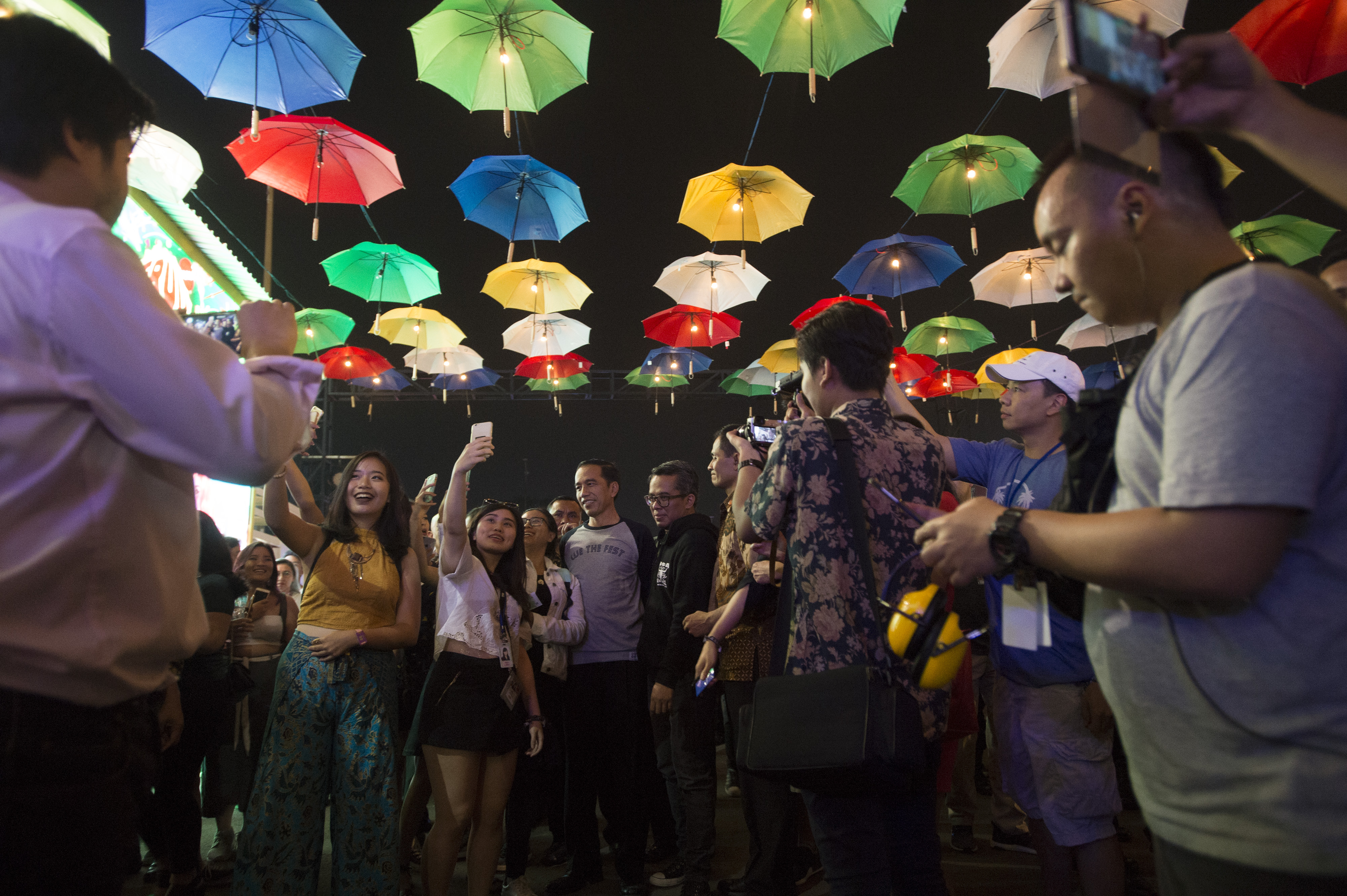 Presiden Joko Widodo (tengah) diajak berfoto oleh para penonton saat melihat konser We The Fest di JIExpo, Jakarta, Jumat (11/8). 
