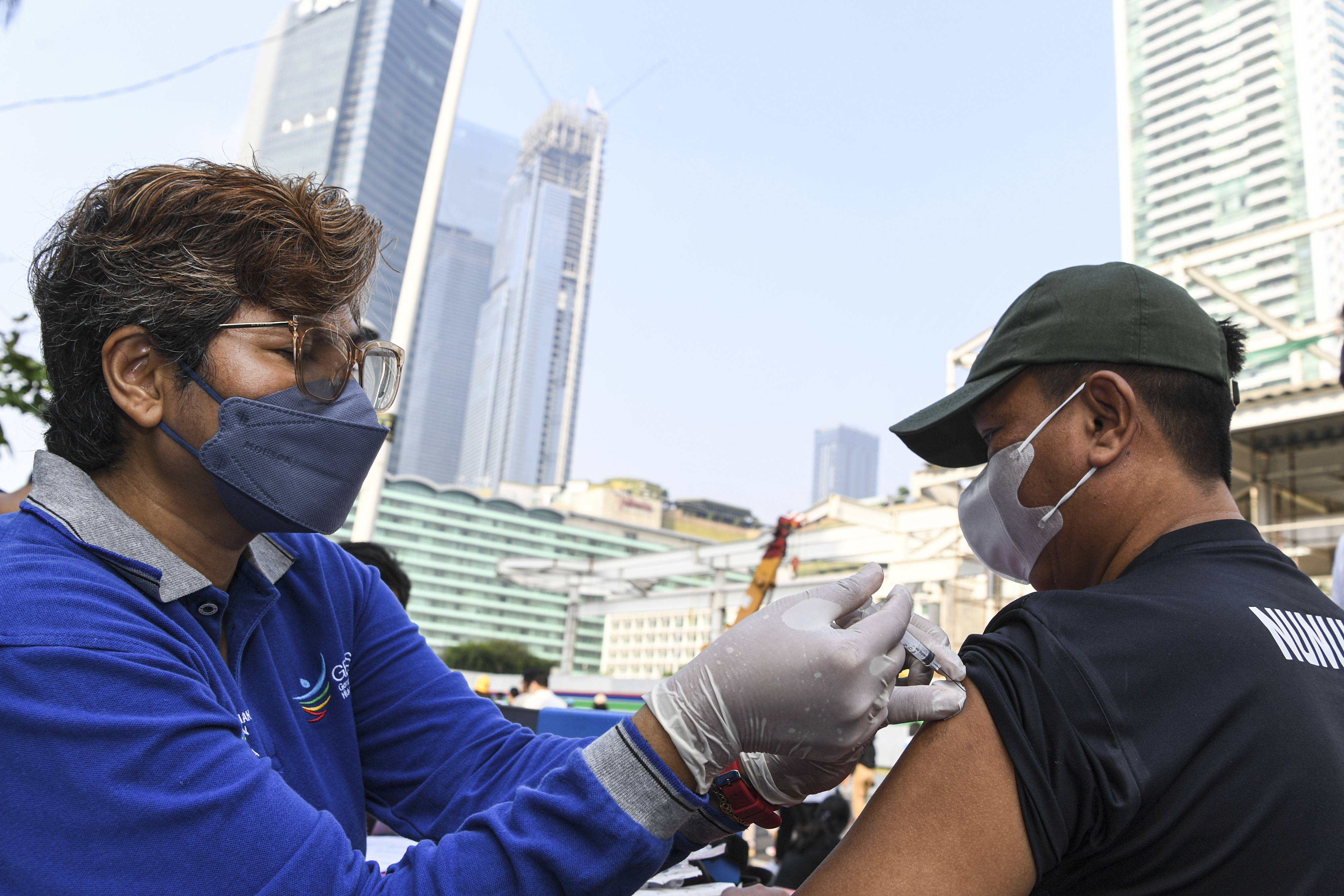 Petugas kesehatan menyuntikkan vaksin covid-19 kepada warga di Jakarta.