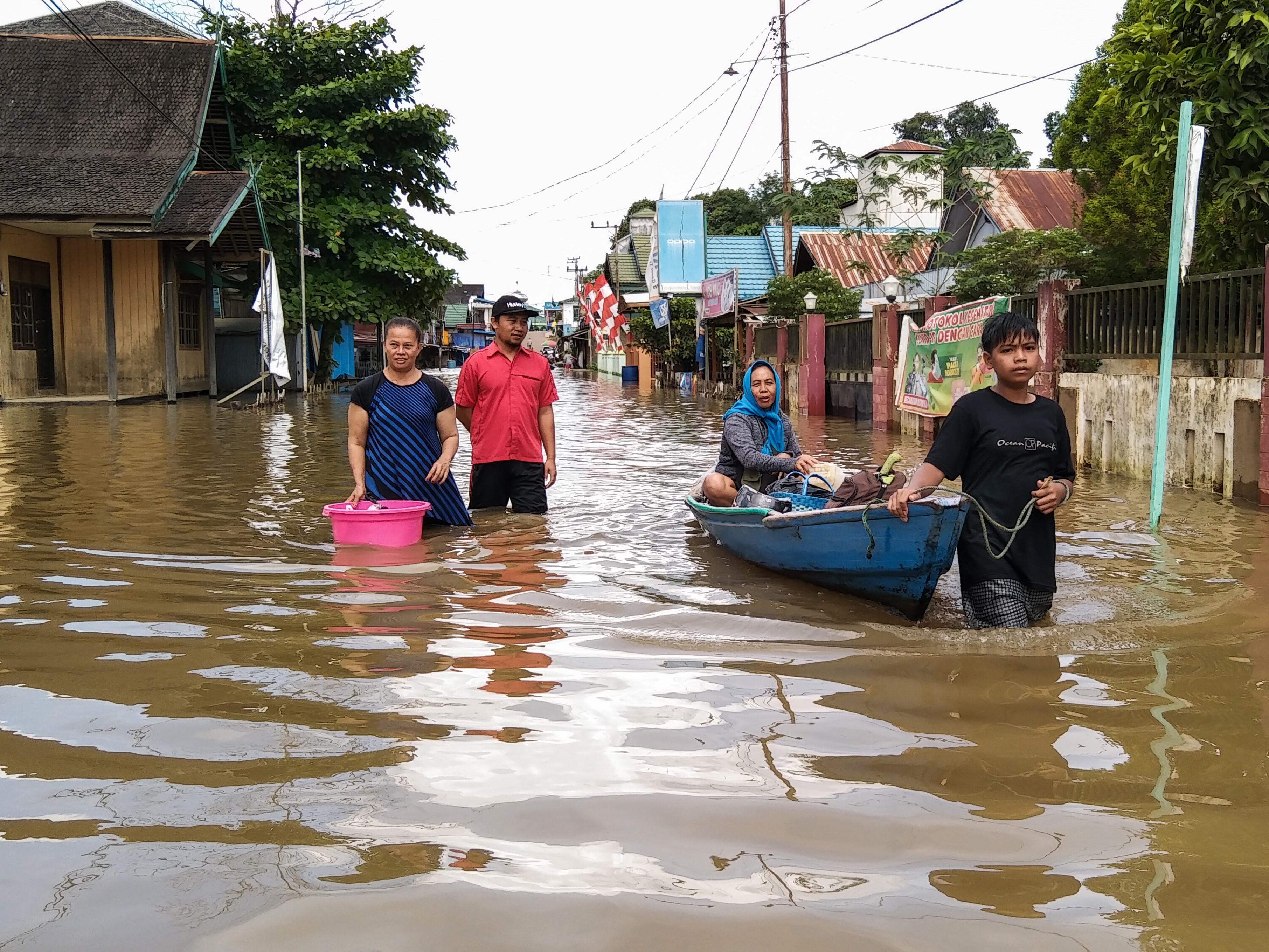 Warga menaiki perahu bermesin saat banjir terjadi di permukiman Desa Mentaya Hulu, Kotawaringin Timur, Kalimantan Tengah, Kamis (7/10/2021).