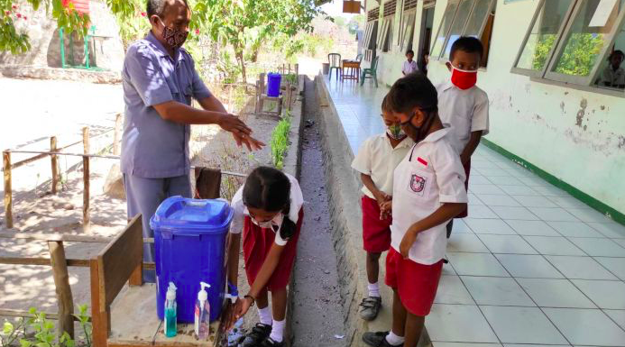 Siswa dan siswi SDI Uwa sedang mencuci tangan sebelum masuk kelas.