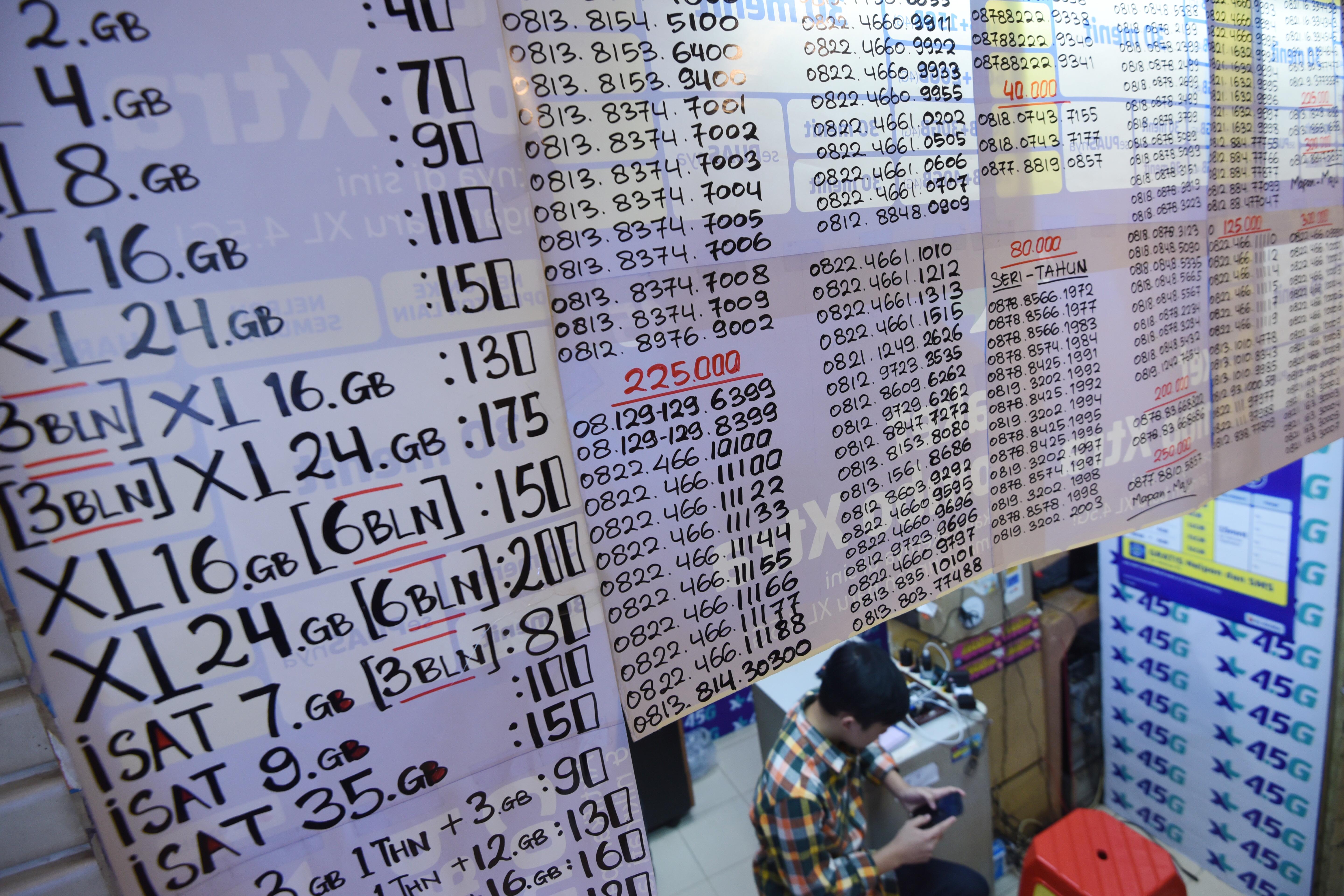  Pedagang meregistrasi kartu prabayar pada gerai miliknya di Mall Ambasador, Jakarta