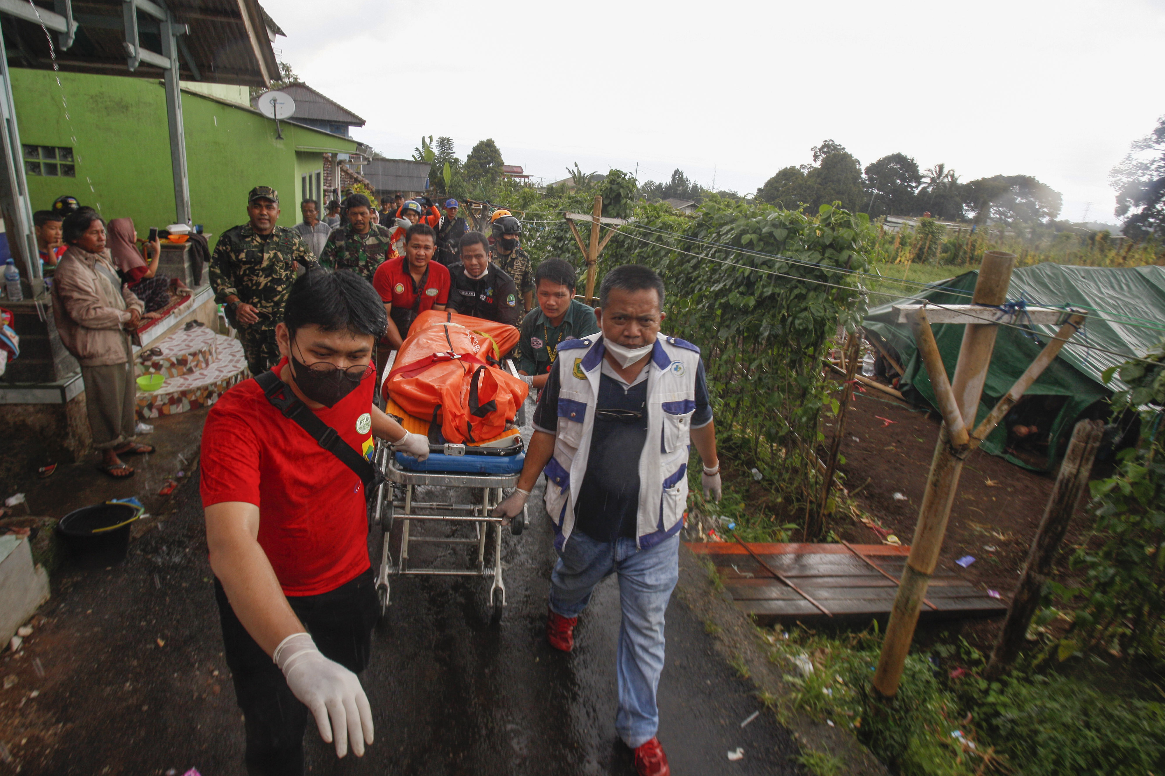 Tim gabungan membawa kantong jenazah korban tertimbun material bangunan akibat gempa di Desa Cibereum Keler, Cugenang, Selasa (22/11).