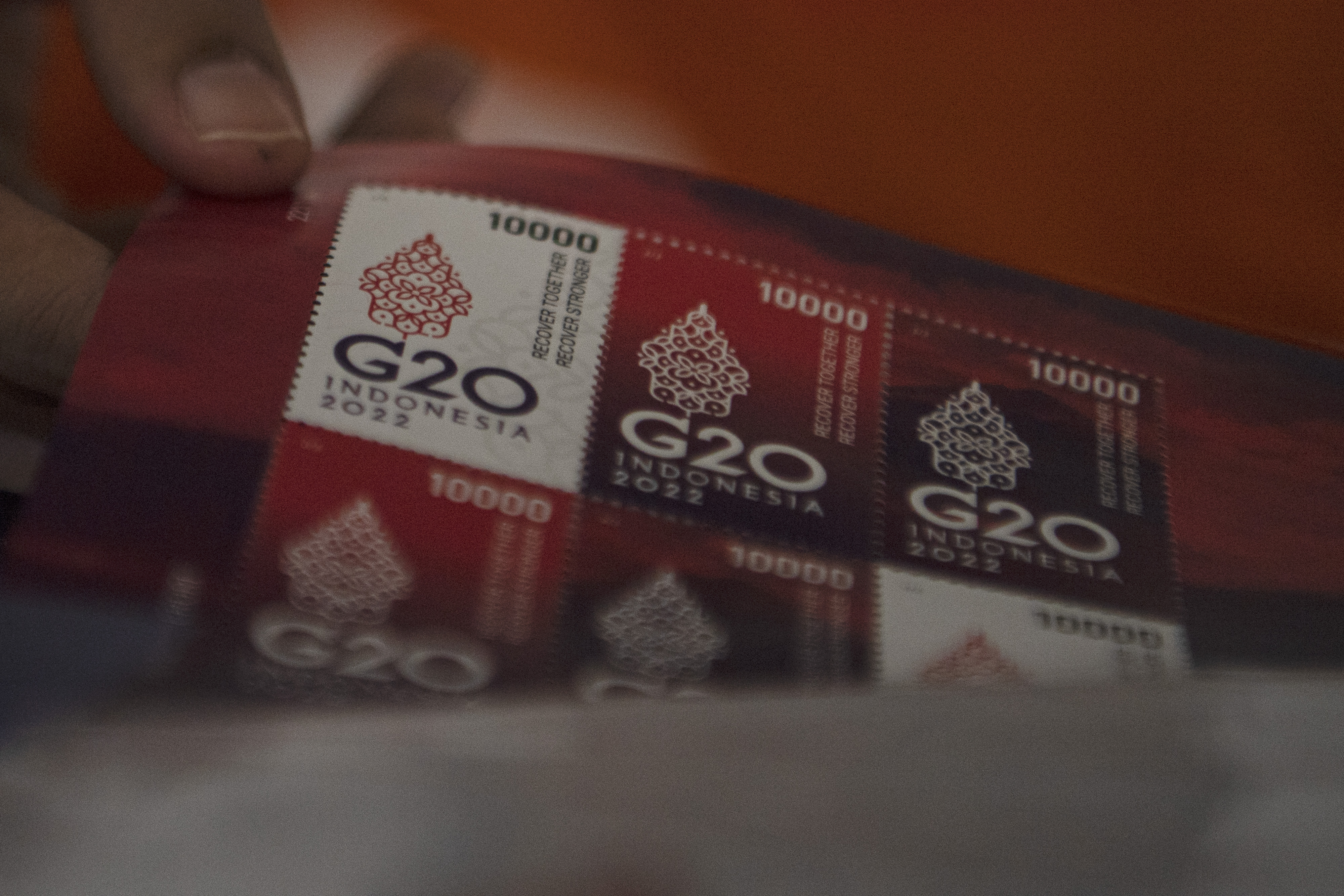 Petugas menyusun prangko seri G20 2022 di kantor pos.