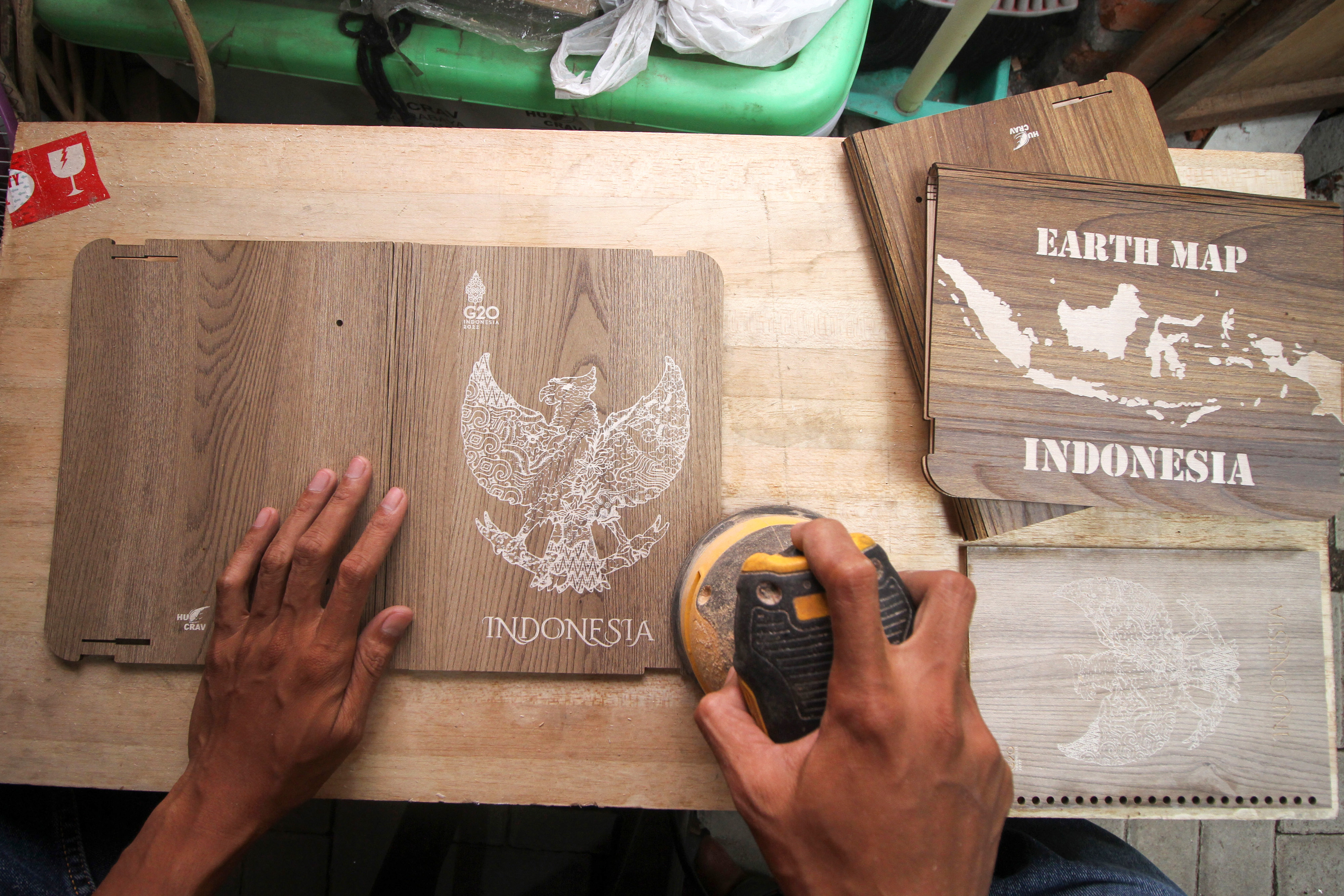Perajin menyelesaikan pembuatan kerajinan kayu suvenir resmi KTT G20 Bali di Kawasan Wedoro, Sidoarjo.