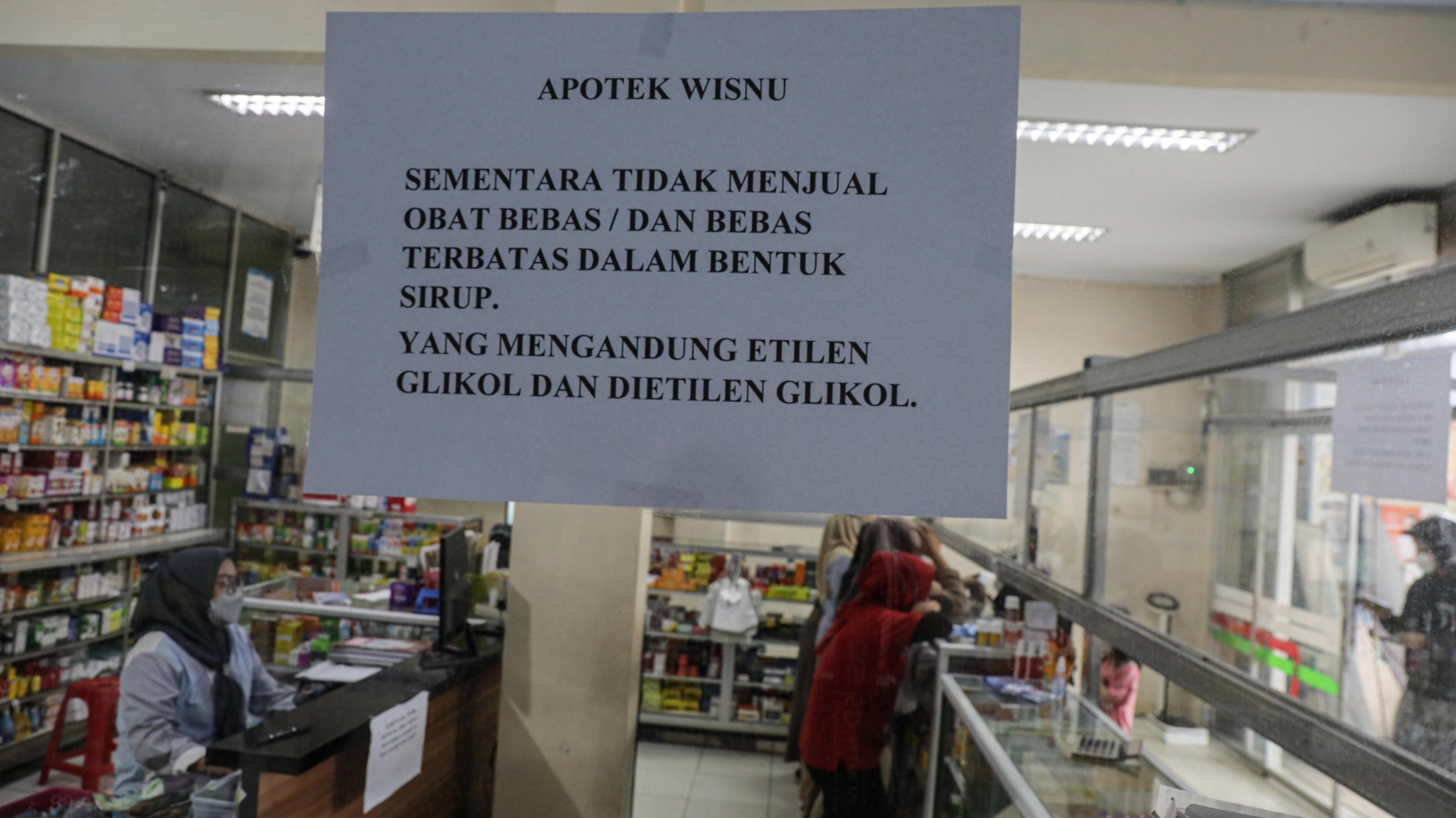 Tulisan pemberitahuan perihal penghentian sementara penjualan obat sirop di apotek Wisnu, Ciledug, Kota Tangerang, Banten