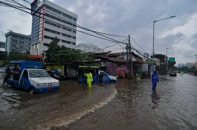 Sejumlah kendaraan melintasi banjir di jalan Bungur Besar Raya, Kemayoran, Jakarta Pusat, Selasa (18/1).