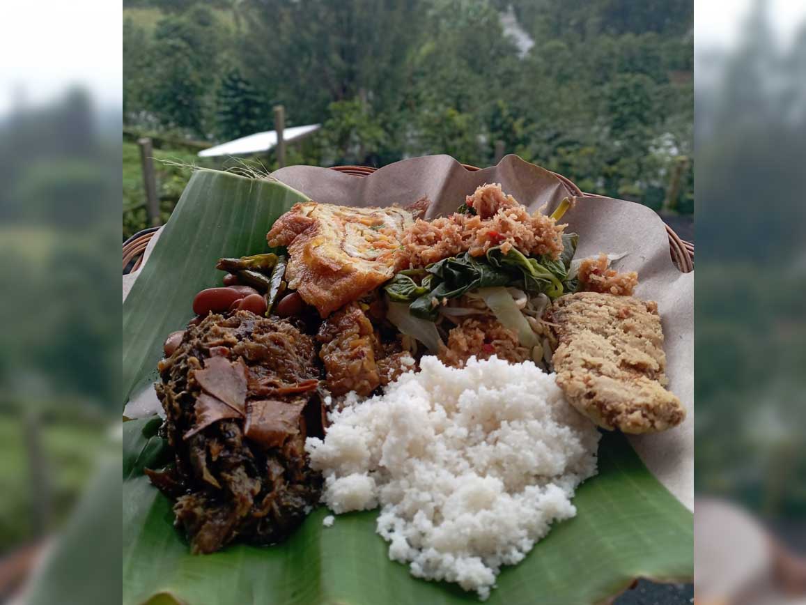 Nasi jagung dengan lauk buntil daun singkong, sayur krecek, tumis tempe cabe ijo, urap-urap, ikan asin, dan telur dadar