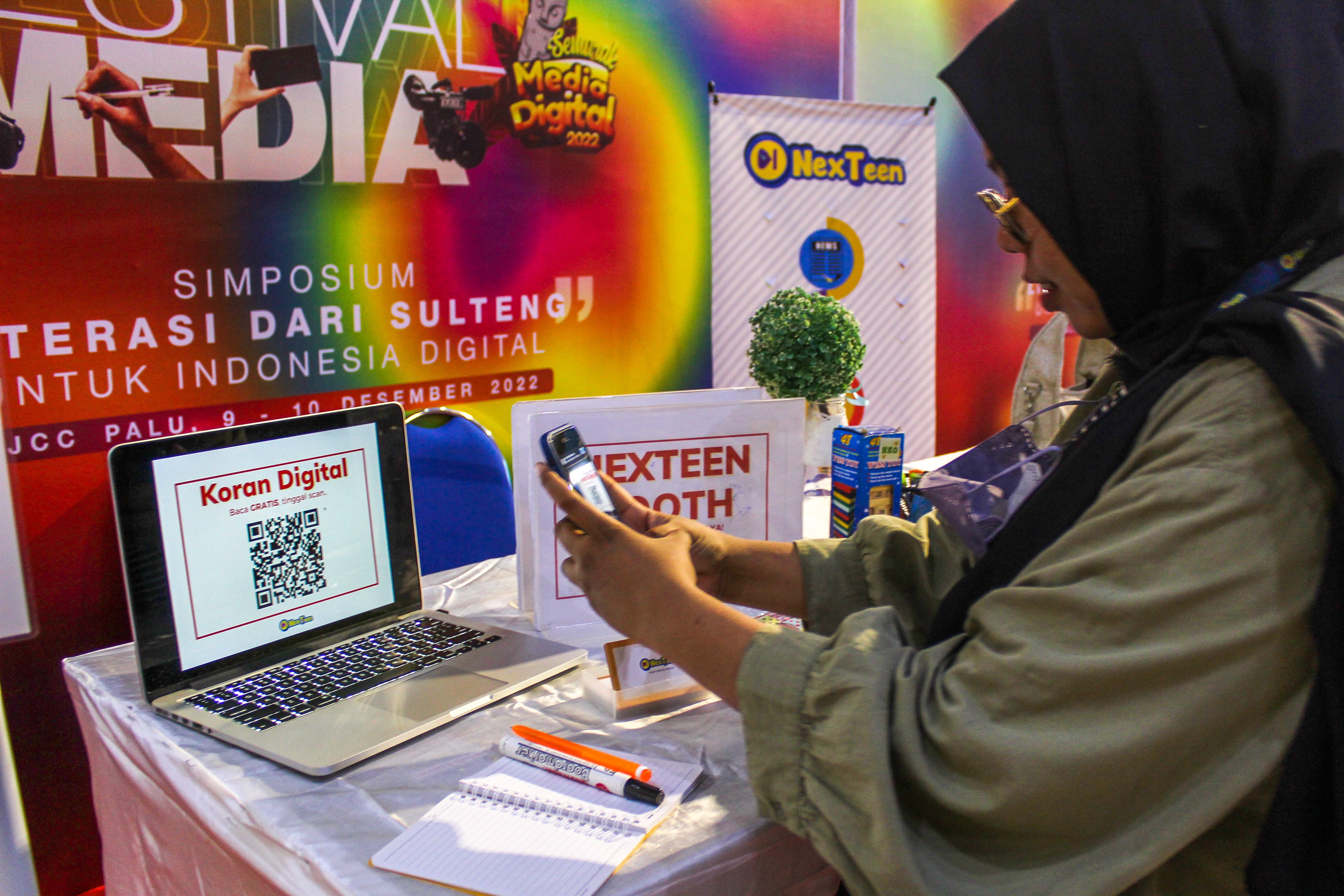 Pengunjung memindai kode batang untuk mengakses koran digital pada Festival Literasi Media Digital.