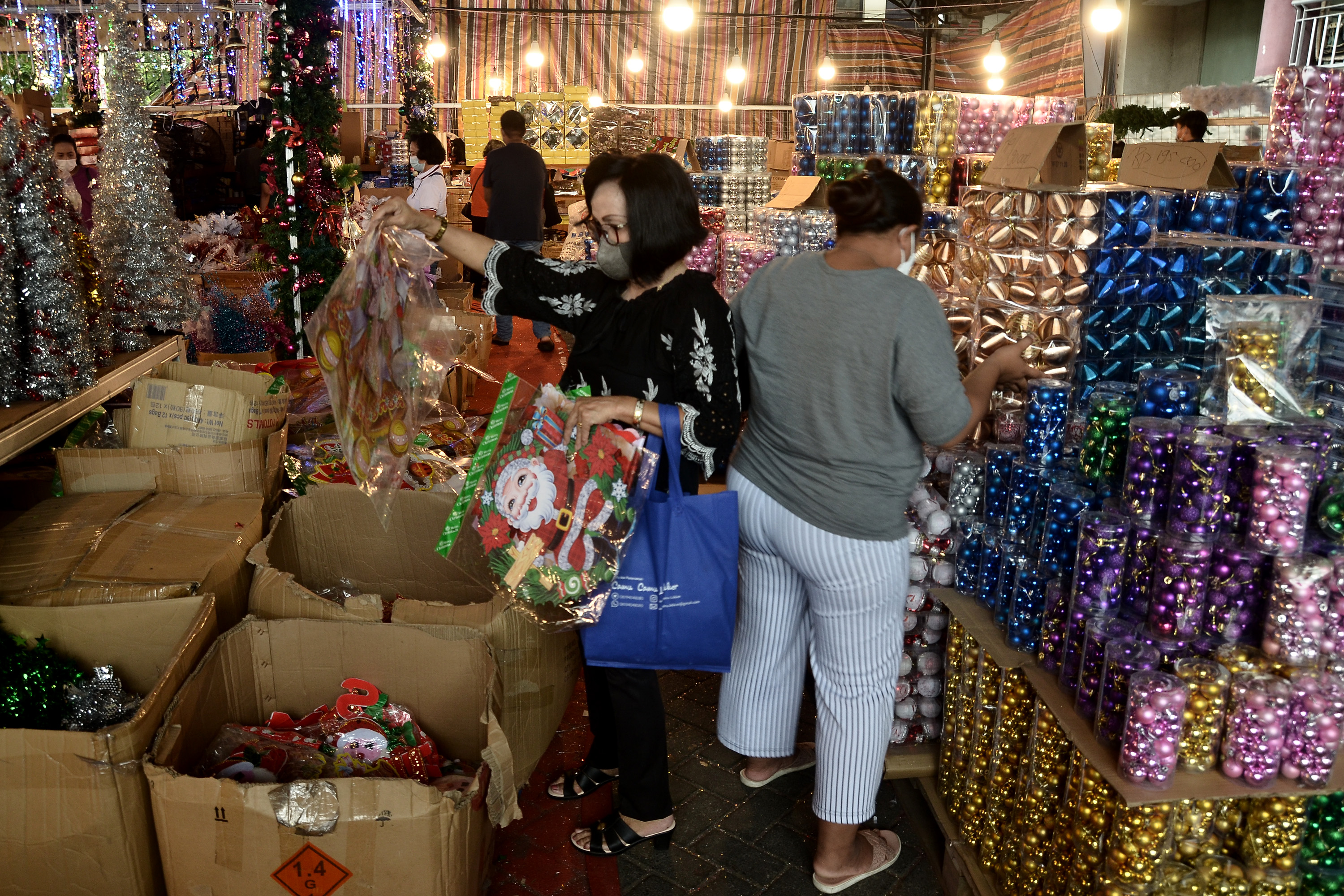 Pengunjung melihat dekorasi hiasan bertema Natal yang dijual di Kawasan Megamas, Manado, Sulawesi Utara.