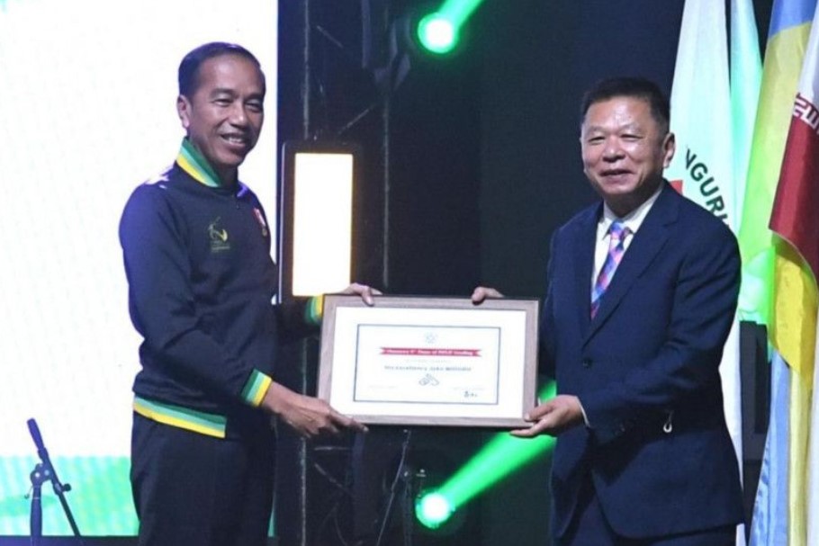 Presiden Joko Widodo (kiri) menerima penghargaan tertinggi dalam olahraga wushu saat pembukaan Kejuaraan Dunia Wushu Junior 2022.