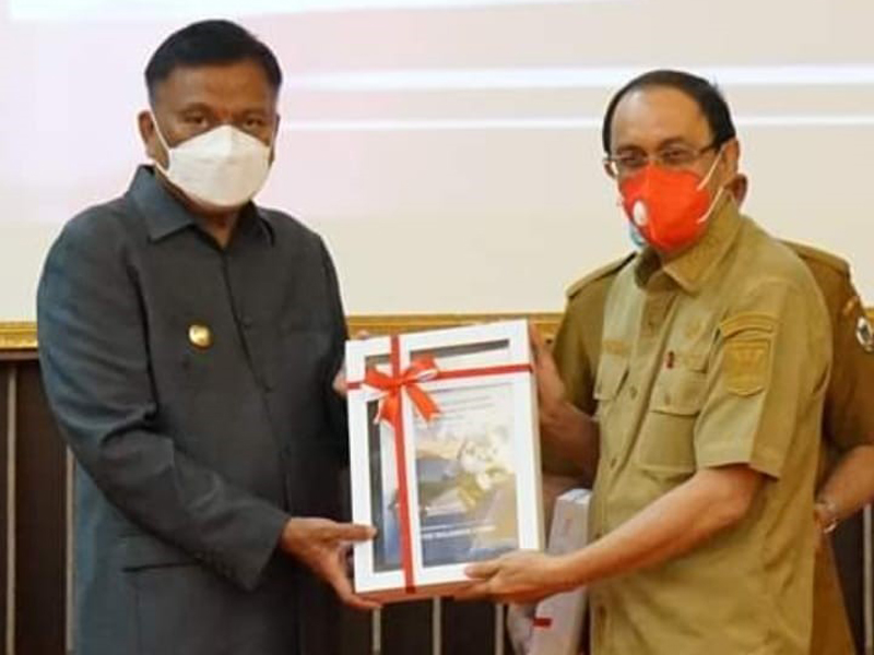 Gubernur Sulawesi Utara Olly Dondokambey menyerahkan piagam penghargaan dari KPK kepada  Bupati Kabupaten Minahasa Royke Octavian Roring.