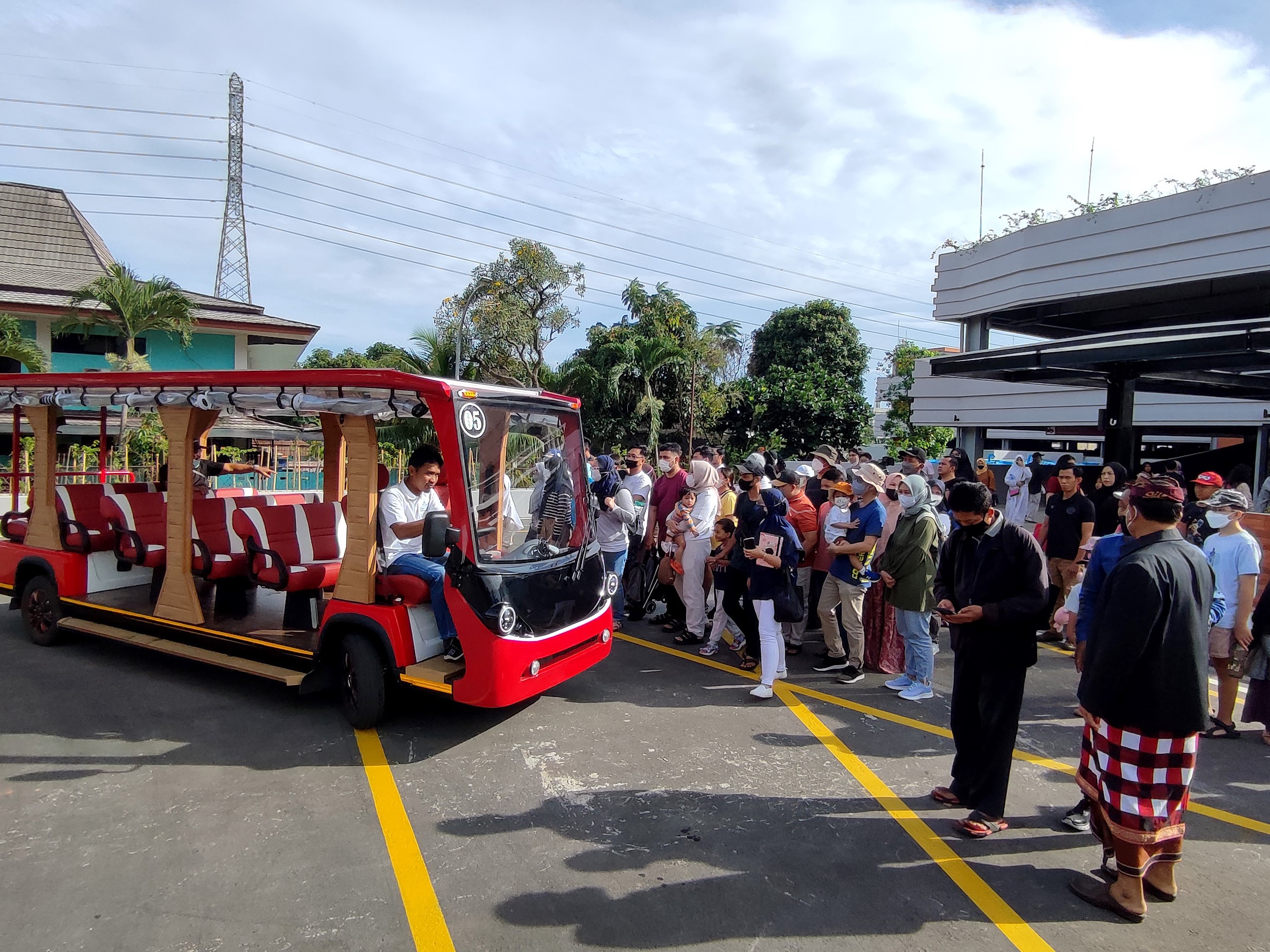 Pengunjung menaiki kendaraan listrik untuk masuk ke kawasan Taman Mini Indonesia Indah (TMII), Jakarta, Minggu (20/11/2022).