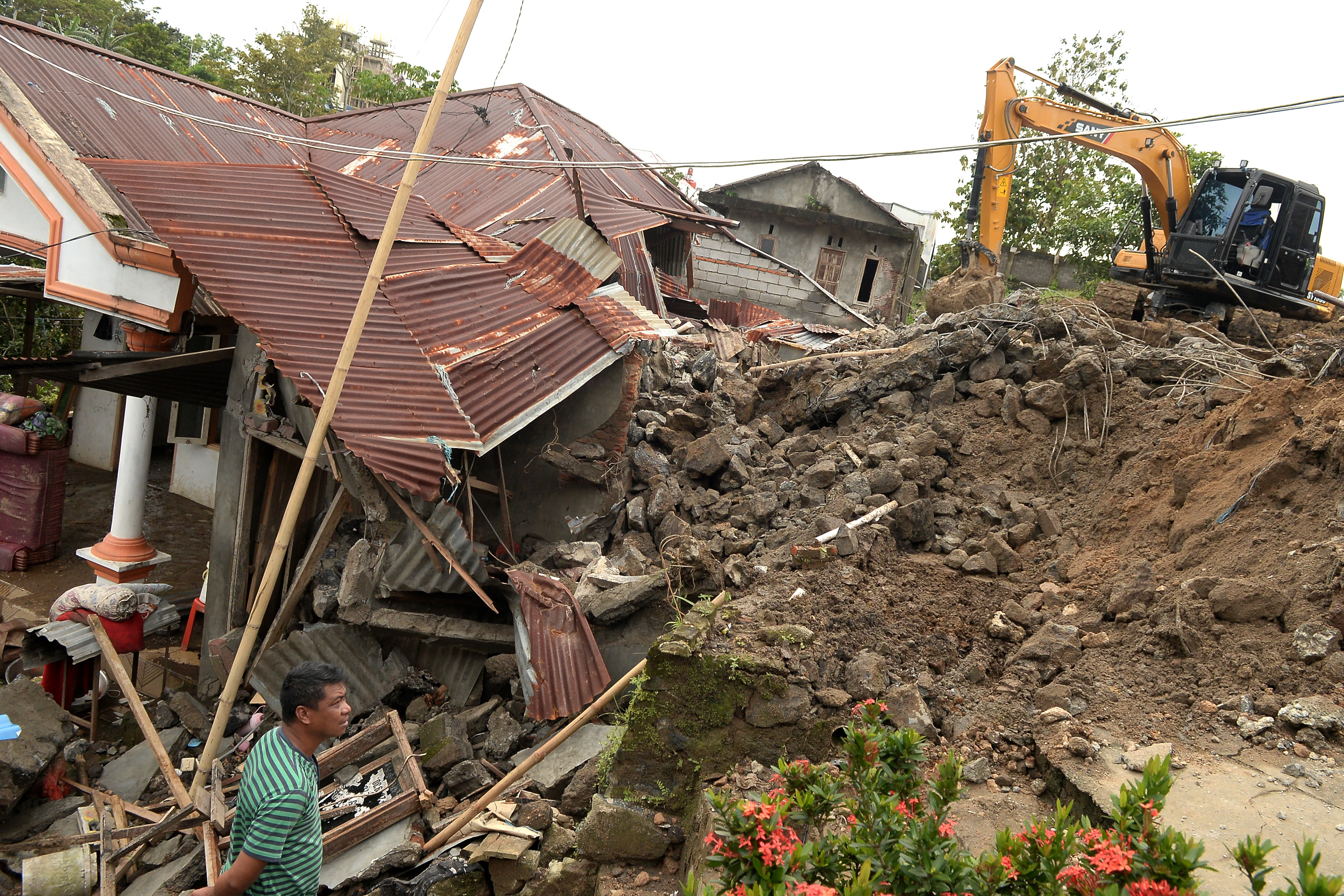 Proses penggalian rumah yang terdampak longsor di Kelurahan Singkil Dua, Manado, Sulawesi Utara, Sabtu (28/1).