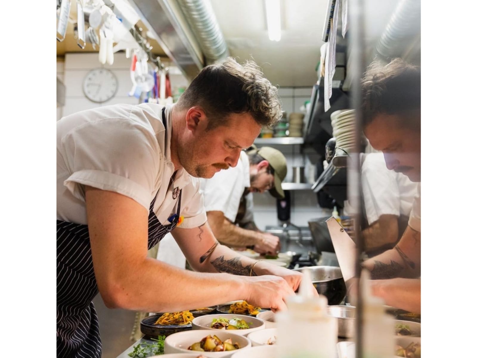 Chef Devon Latte dari The Acorn, Kanada, tengah menyiapkan sajian. 