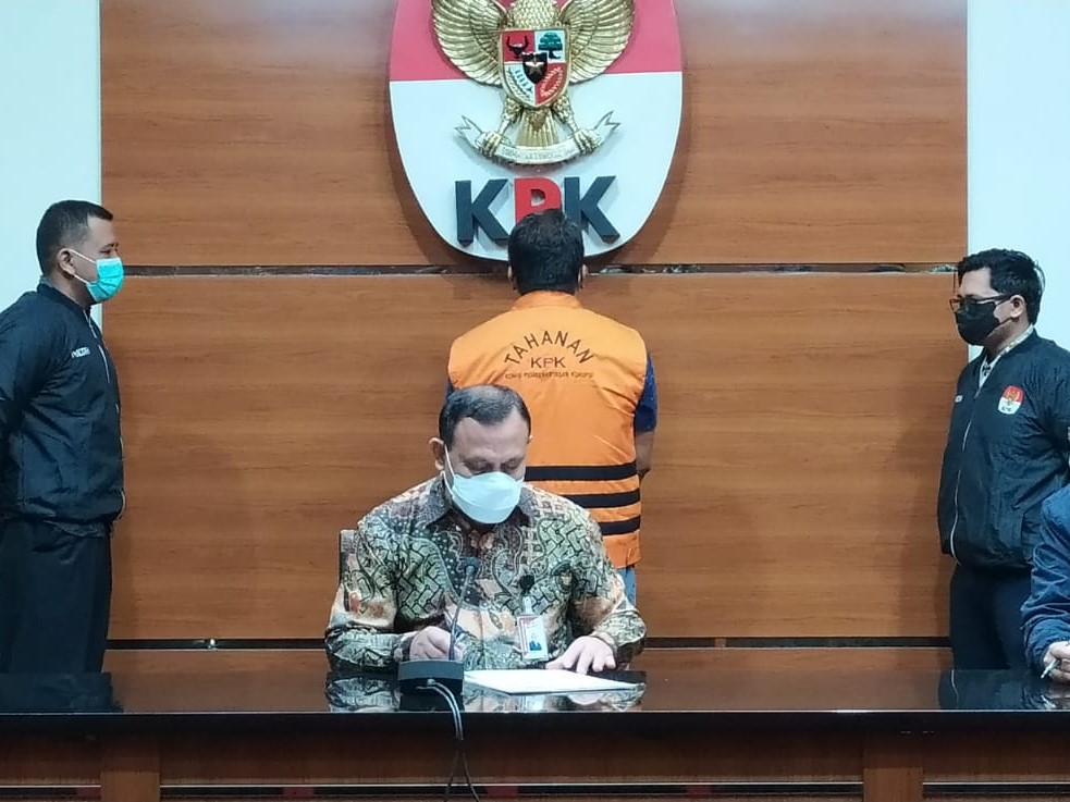 Ketua KPK Firli Bahuri dengan latar belakang Bambang Kayun yang memakai rompi tahanan.