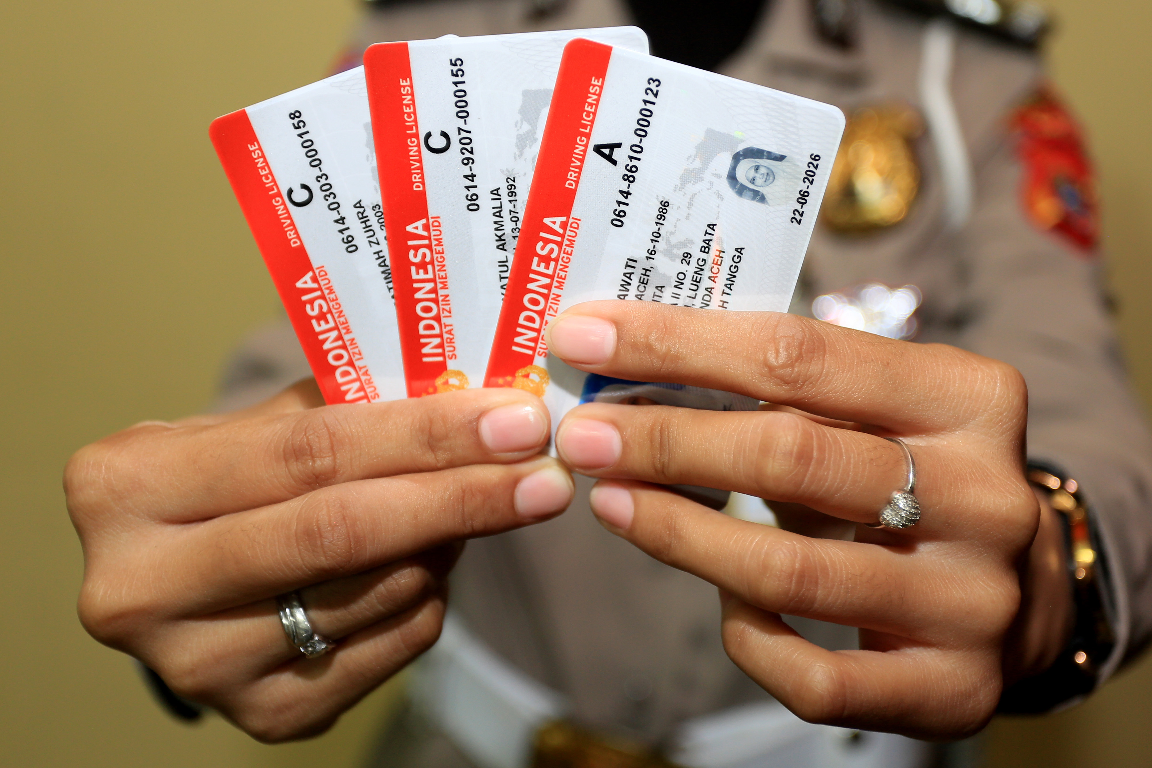 Ilustrasi petugas kepolisian menunjukkan surat izin mengemudi (SIM).