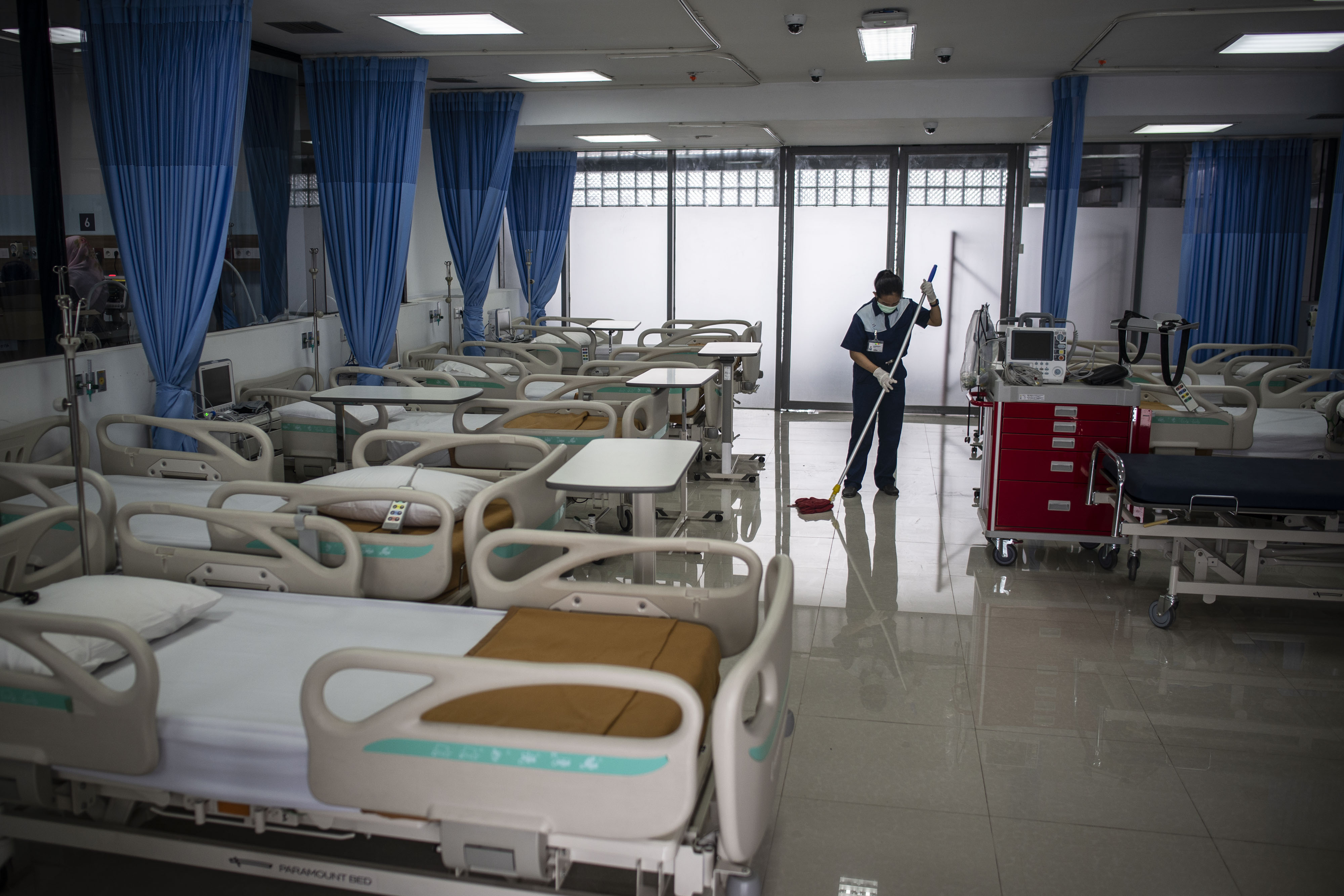 Petugas kebersihan membersihkan lantai di salah satu ruangan yang dijadikan Rumah Sakit Darurat di Gedung Lippo Plaza Mampang