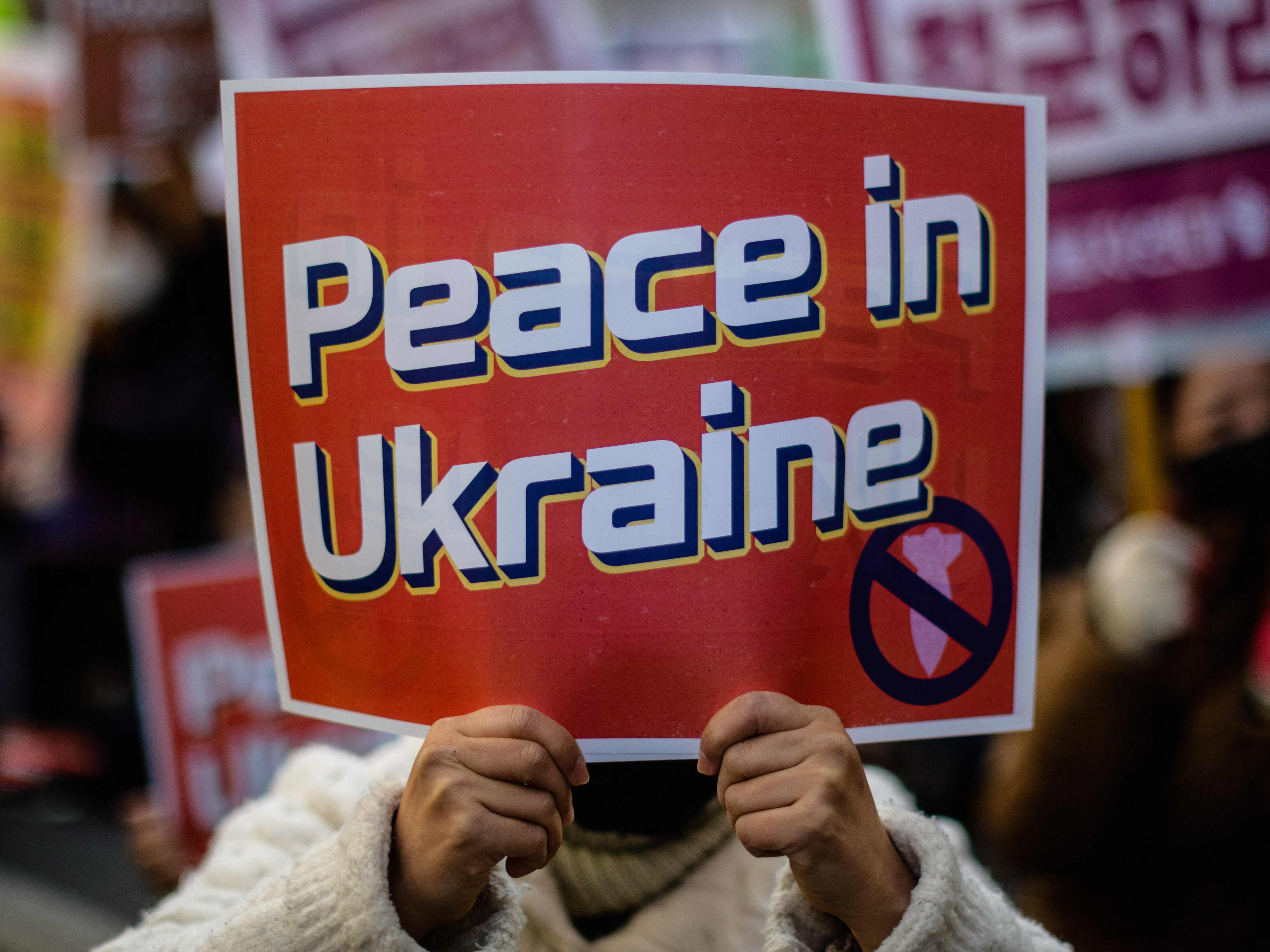 Orang-orang berkumpul selama protes untuk menandai satu tahun sejak invasi Rusia ke Ukraina di Seoul pada 25 Februari 2023.