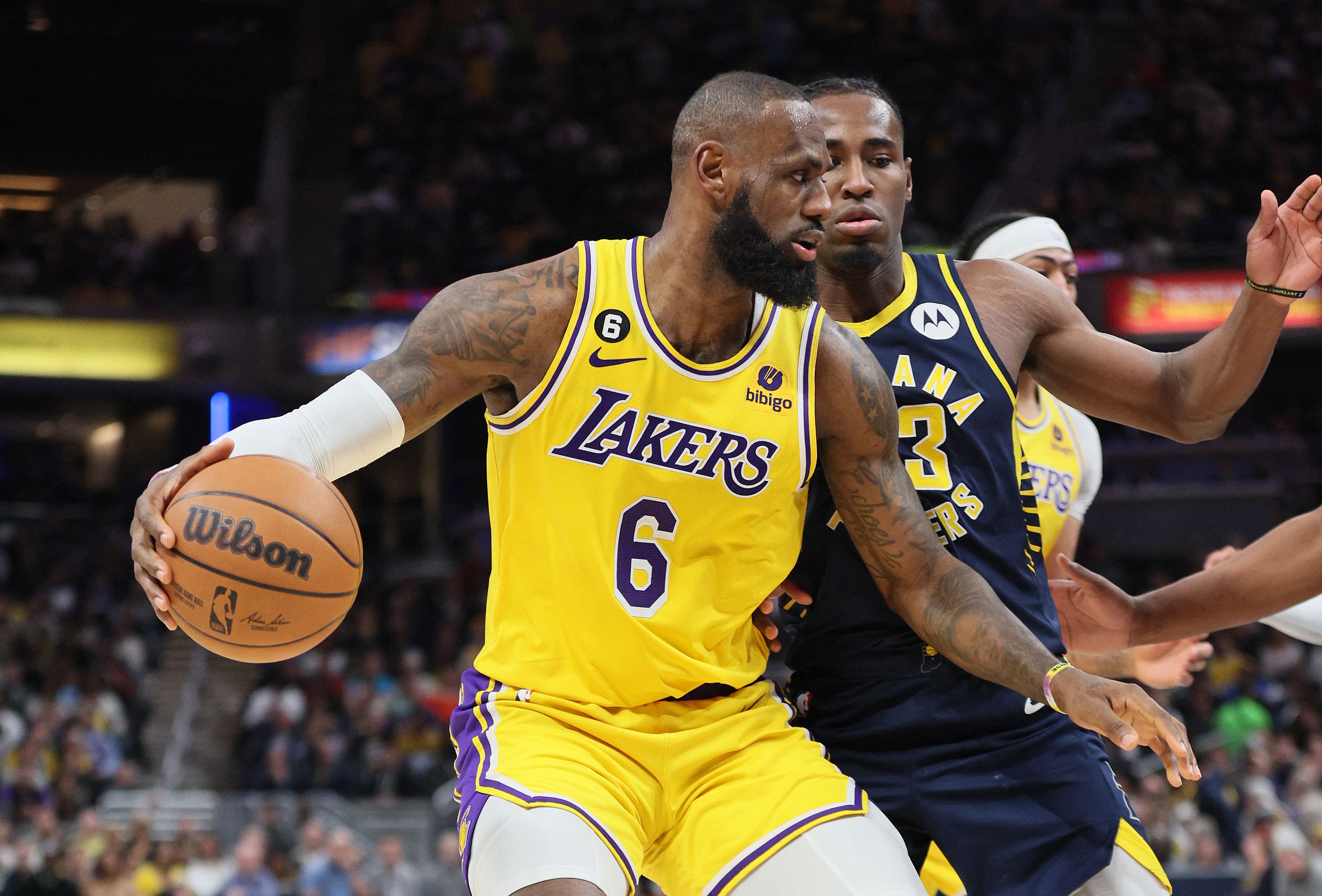 Bintang Los Angeles Lakers LeBron James berusaha melewati hadangan pemain Indiana Pacers di laga NBA.