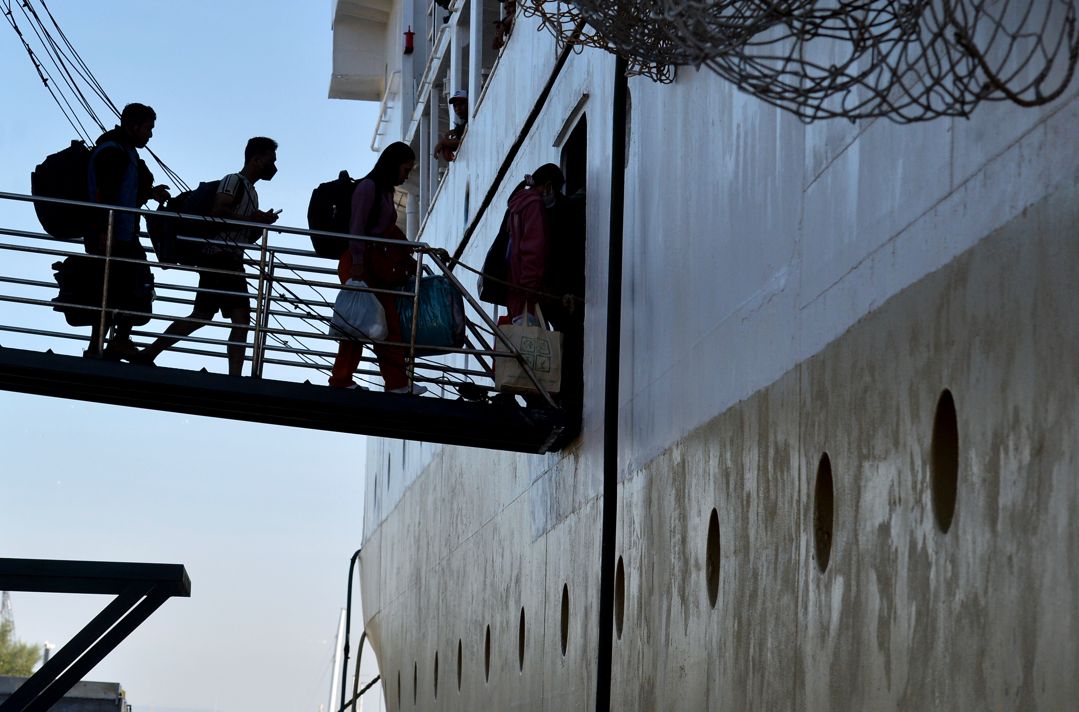 Calon penumpang berjalan memasuki KM Binaiya yang bersandar di Pelabuhan Benoa, Denpasar, Bali,