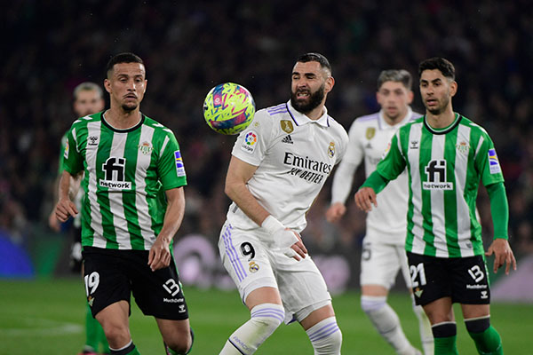 Karim Benzema memperebutkan bola dengan pemain bertahan Real Betis Luiz Felipe 