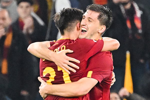 Pemain AS Roma Marash Kumbulla memeluk rekan setimnya Paulo Dybala setelah mencetak gol ke gawang Real Sociedad.