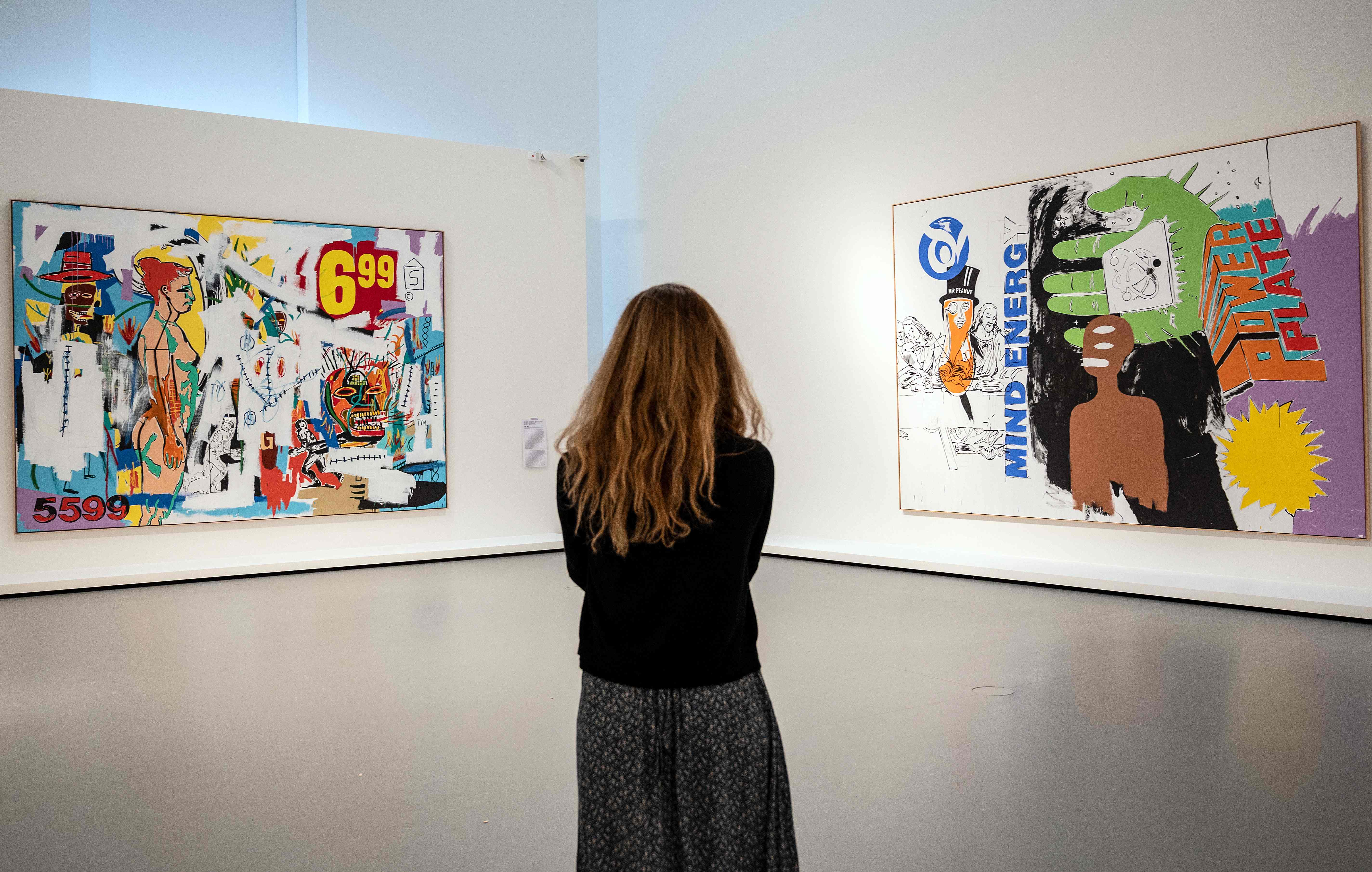 Pengunjung melihat karya kolaborasi Jean-Michel Basquiat dan Andy Warhol yang dipamerkan di Paris
