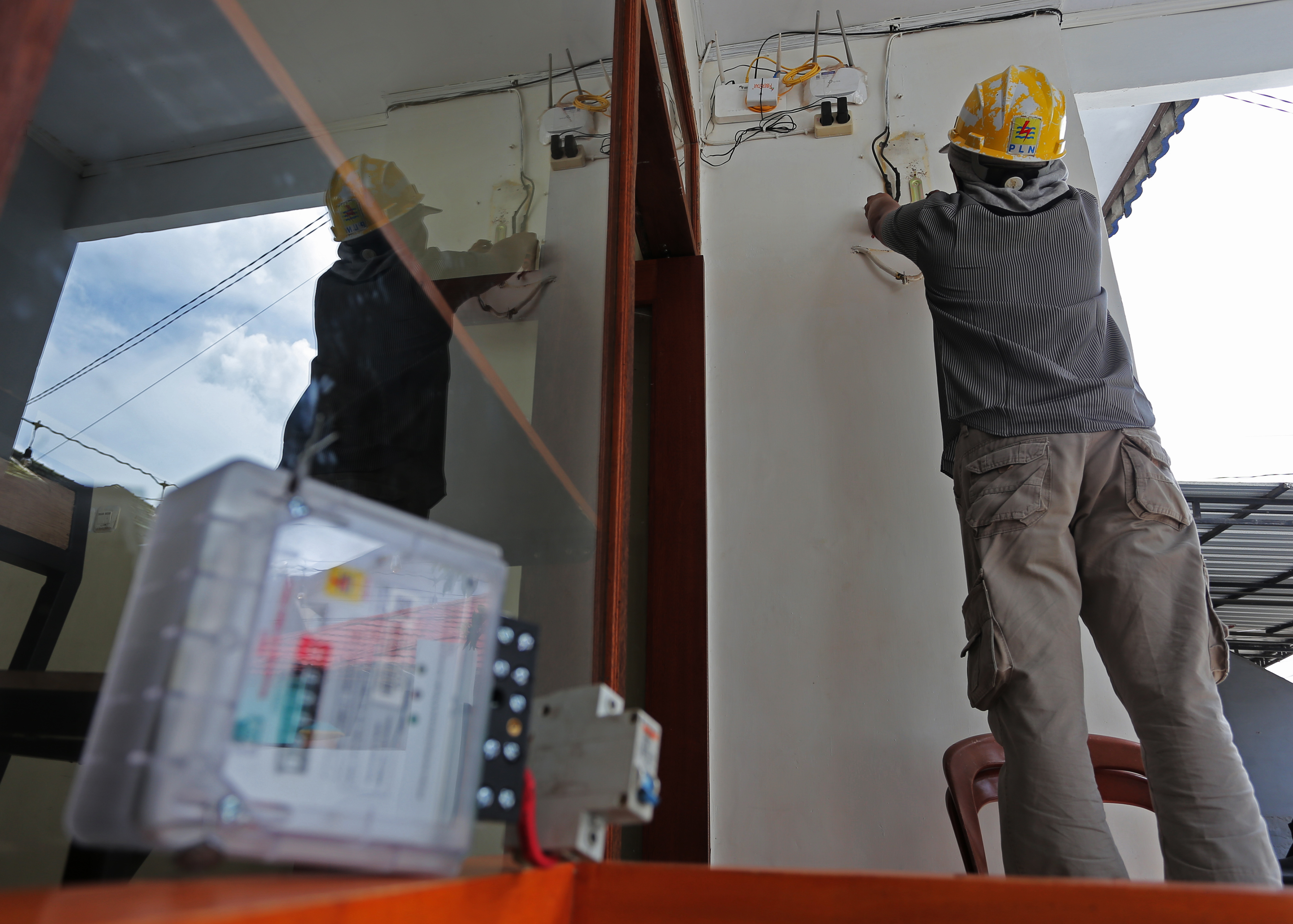 Petugas mengganti meteran milik pelanggan. 